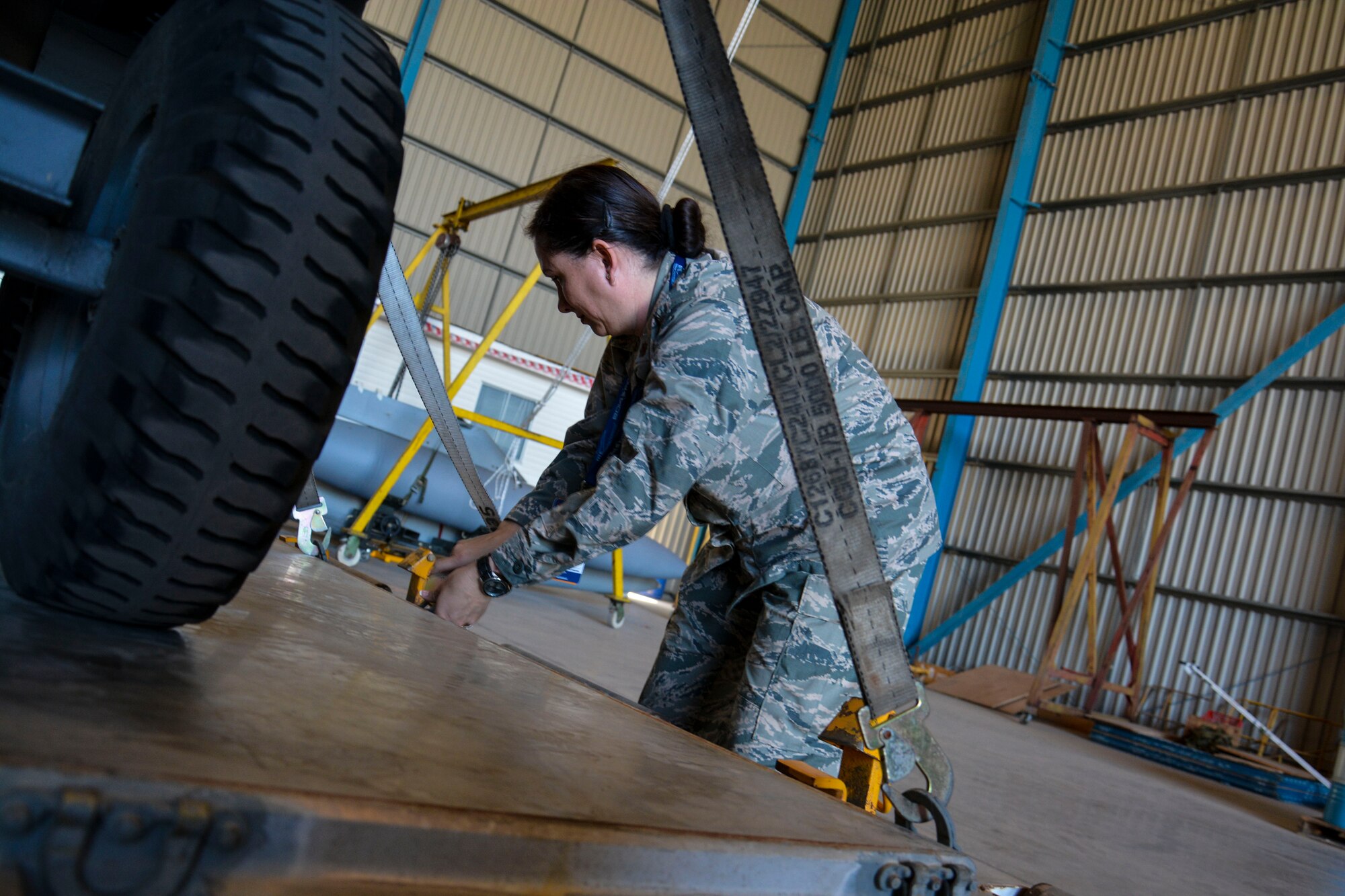 Major Camille LaDrew, a logistics officer from the Texas Air National Guard, ties down F-16 engine equipment and tools in Santiago, Chile, March 24.  Major LaDrew is one of nearly 60 U.S. Airmen participating in subject matter expert exchanges with Chilean air force counterparts, and involved in hosting static displays of the C-130 Hercules and F-16 Fighting Falcon during the FIDAE Air Show in Santiago, March 25 through 30. The exchanges, conducted regularly throughout the year, involve U.S. Airmen sharing best practices and procedures to build partnerships and promote interoperability with partner-nations throughout South America, Central America and the Caribbean. (U.S. Air Force photo by Capt. Justin Brockhoff/Released)