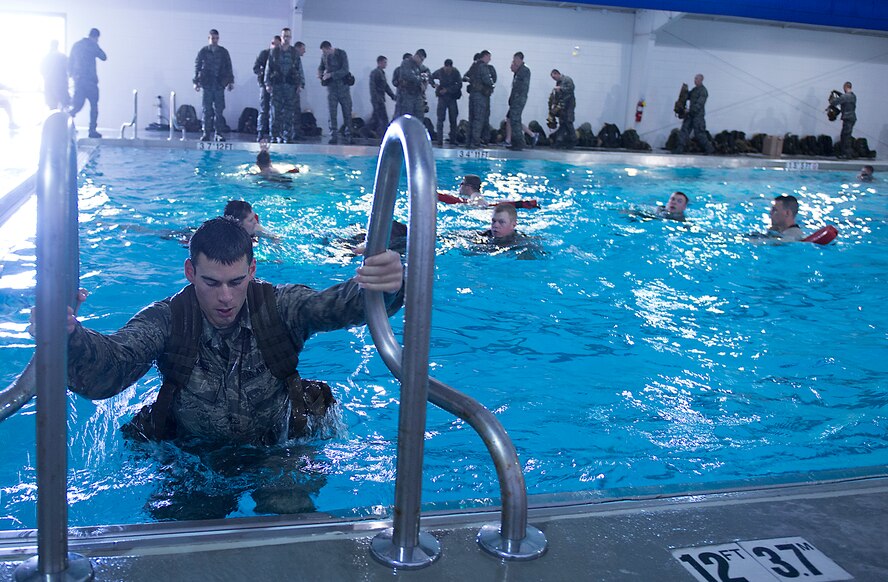 An air liaison officer (ALO) candidate climbs out of the pool during an ALO Aptitude Assessment (AAA) held by the 93d Air Ground Operations Wing at Moody Air Force Base, Ga., March 19, 2014. The 93rd AGOW AAA is done three times per year; twice at Moody and once at the Air Force Academy in Colorado Springs, Colo. (U.S. Air Force photo by Senior Airman Tiffany M. Grigg/Released)