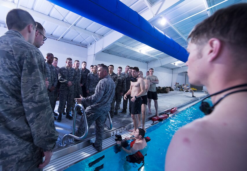 U.S. Air Force Capt. John Grucella, 93d Air Ground Operations Wing air liaison officer (ALO) aptitude assessment (AAA) Phase II program manager (center), instructs 38  ALO candidates on how their water confidence will be tested at Moody Air Force Base, Ga., March 19, 2014. The AAA is the second phase of a three phase process for both cadets and current officers interested in joining the ALO career field. (U.S. Air Force photo by Senior Airman Tiffany M. Grigg/Released) 