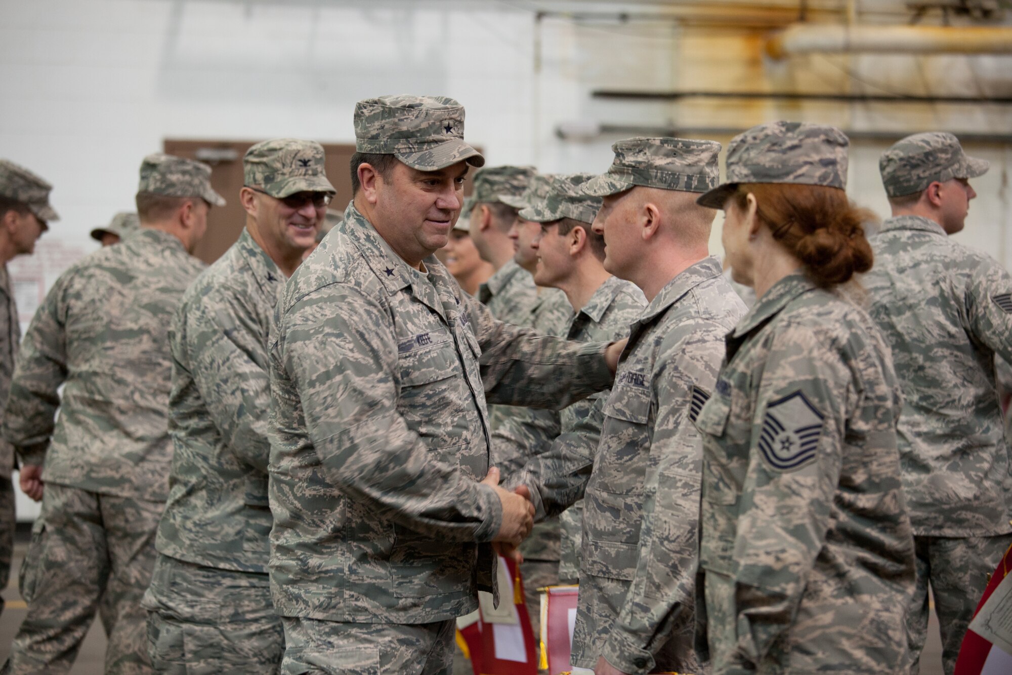 Brig. Gen. Gary W. Keefe, Massachusetts Air National Guard Commander, shakes hands with members of the 212th Engineering Installation Squadron and their families at Otis Air National Guard Base, Mass. on March 21, 2014. Members of the 212th will be deploying in support of Operation Enduring Freedom from late March to late November. (National Guard photo by Staff Sgt Jeremy Bowcock/Released)