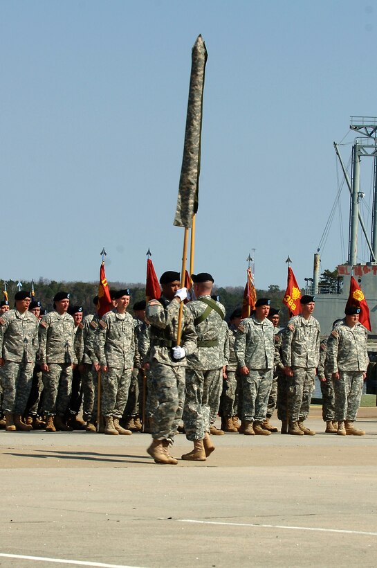 U.S. Army Soldiers of the 7th Transportation Brigade (Expeditionary) exchange the 7th Sustainment Bde. colors for the new 7th Trans. Bde. (Ex.) colors during a transformation ceremony at Fort Eustis, Va., March 21, 2014. The 7th Trans Bde. (Ex.) will plan and manage watercraft and water terminal support for theater operations, and commit terminal and watercraft assets in support of theater deployment and movement operations. (U.S. Air Force photo by Senior Airman Teresa J.C. Aber/Released)
