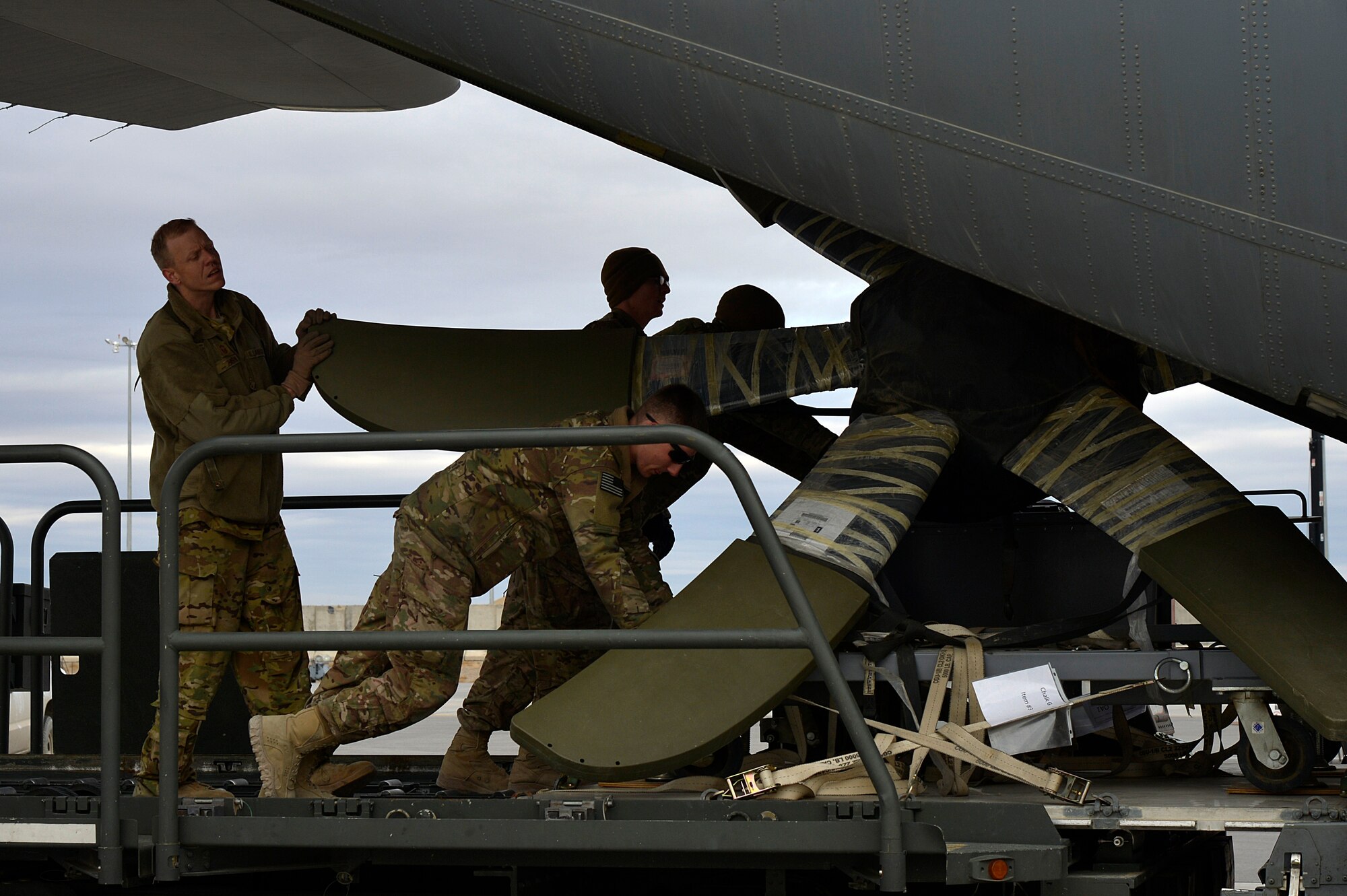 U.S. Air Force airmen assigned to the 774th Expeditionary Airlift Squadron load cargo into a C-130J Super Hercules at Kandahar Airfield, Afghanistan, Jan. 12, 2013. Starting June 1, Airmen deployed to 15 locations globally will see significant changes to pay programs. The biggest change includes the discontinuation of imminent danger pay, or IDP, in multiple countries. (U.S. Air Force photo by Senior Airman Kayla Newman/Released)