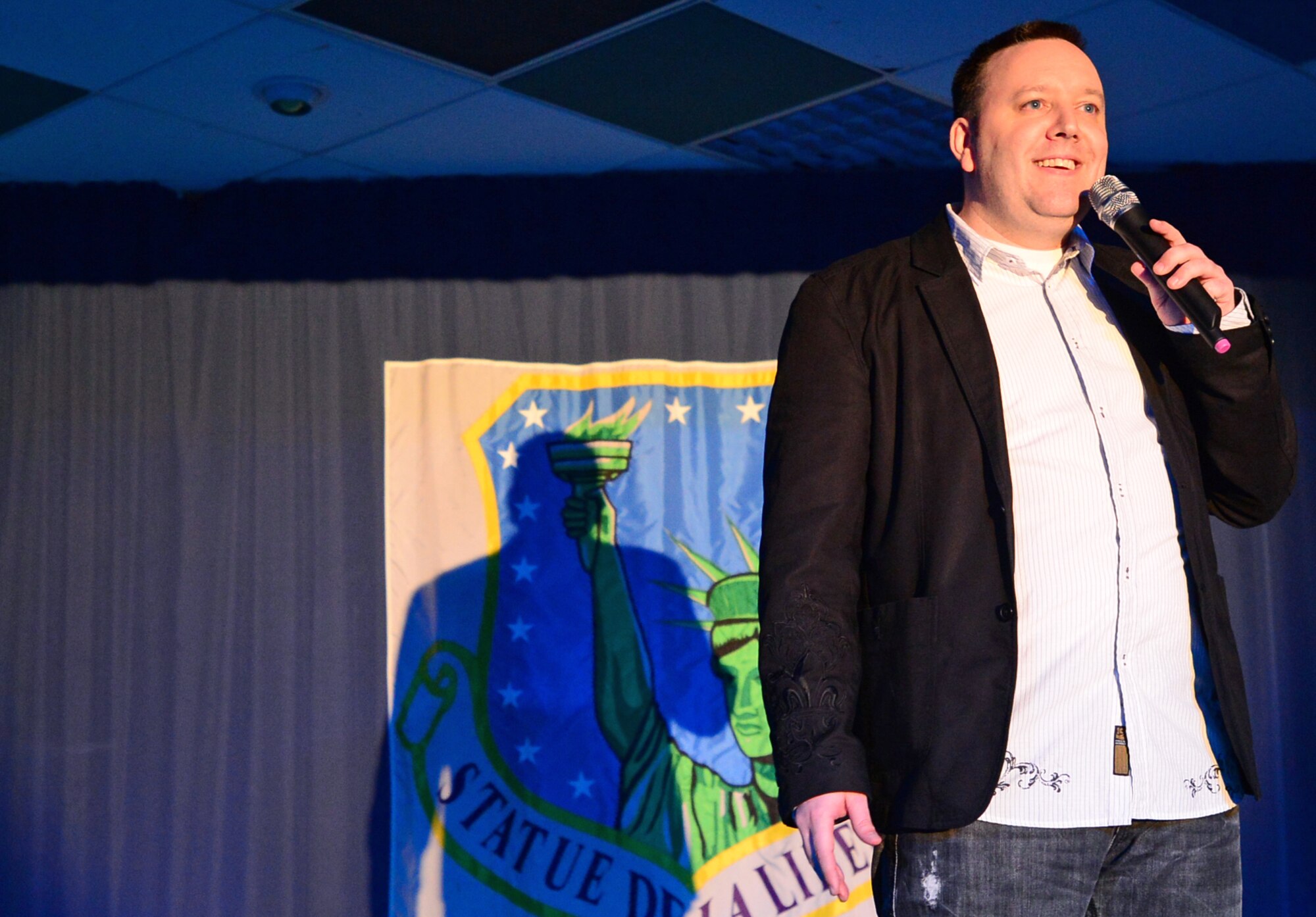Tech. Sgt. David Young, 48th Fighter Wing Command Post, performs at the Liberty Club during Comedy Night at Royal Air Force Lakenheath, England, March 20, 2014. Young was accepted into Tops in Blue as a comedian and soon departs for a nine-month tour performing at various military bases and organizations around the world. Young monitors the wing’s Status of Resource and Training Systems. (U.S. Air Force photo by Airman 1st Class Erin O’Shea/Released)