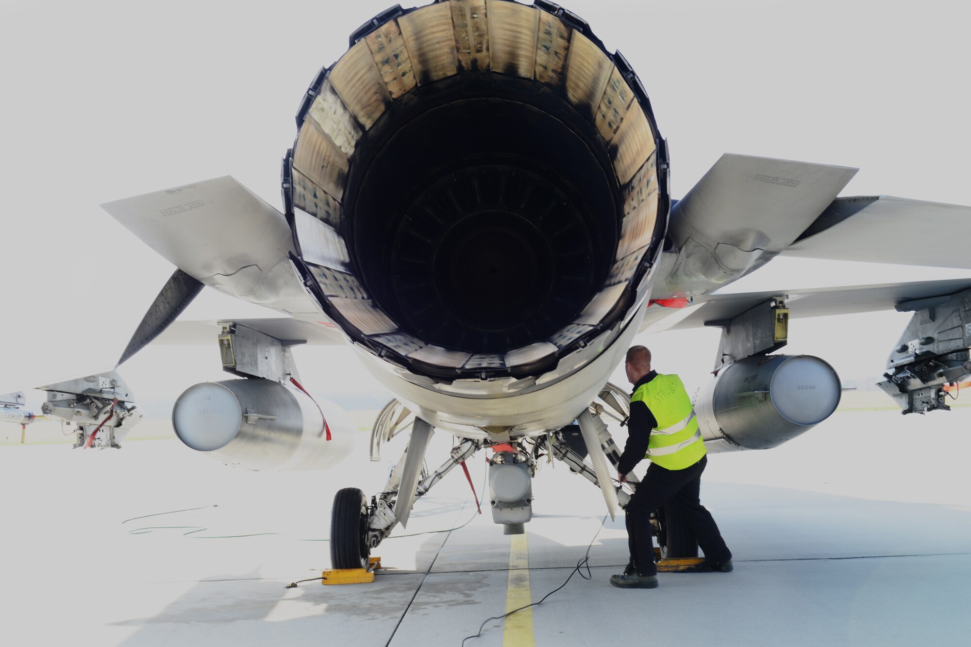 Senior Airman Sean Young, 31st Aircraft Maintenance Squadron crew chief, performs pre-flight checks on an F-16 Fighting Falcon assigned to the 555th Fighter Squadron, March 20, 2014, at Łask Air Base, Poland. Throughout the past week, maintainers from the 31st AMXS, the 555th Aircraft Maintenance Unit and various other maintenance flights have worked together to maintain and repair F-16s involved with numerous training sorties. (U.S. Air Force photo/Airman 1st Class Ryan Conroy/Released) 