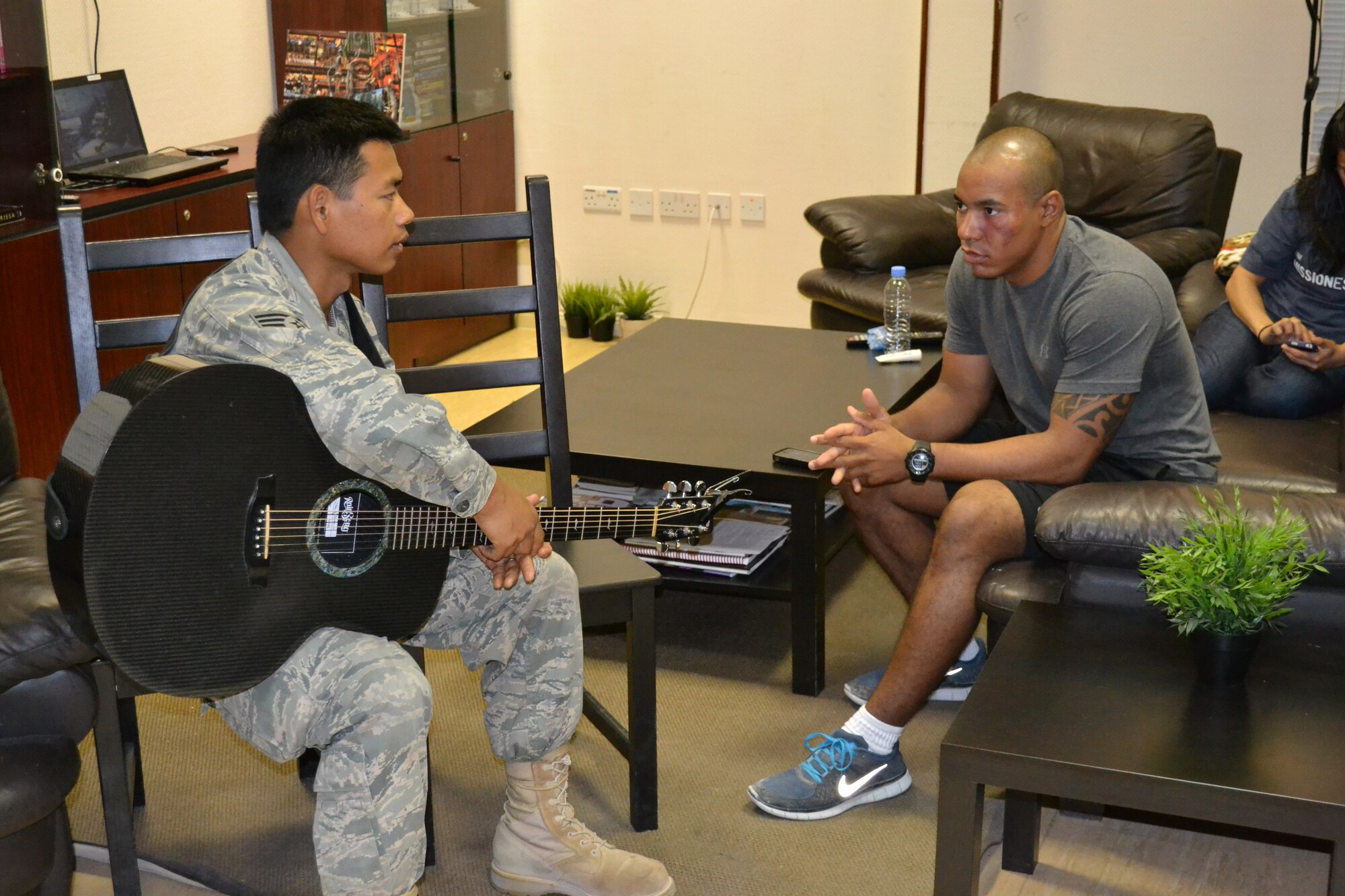 Staff Sgt. Daniel Santos talks with Spc. Franklin Montano, a patient recovering at the Intra-Theater Care Program at Al Udeid Air Base, Qatar, Mar. 24, 2014.  The ITCP is the only recovery facility in the Central Command area of responsibility and wounded warriors from all services are sent here for treatment and recovery in order to return to their deployed location.  Members of “Hypersonic,” the band assigned to U.S. Air Forces Central Command, perform for patients to help boost morale, offering a wide variety of hit songs from genres such as jazz, pop, rock and country.   Santos, a native of Bulacon, Philippines plays acoustic guitar and is deployed from Yokota Air Base, Japan.  Montano, recovering from minor surgery, is deployed to Afghanistan with the 150th Engineer Co. from the New York National Guard, Joint Base McGuire-Dix-Lakehurst, N.J.  (U.S. Air Force Photo by Maj. Nicole David)