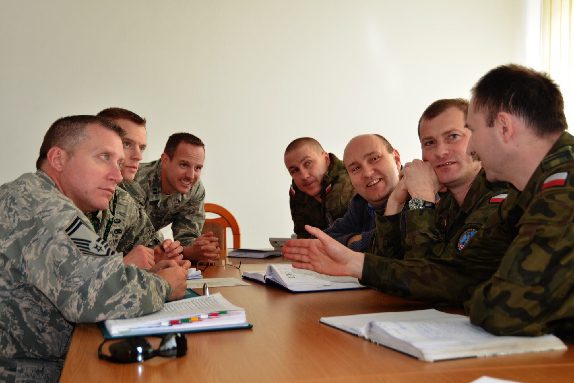 Maintenance leadership from the 31st Fighter Wing and 52nd Operations Group discuss operations with Polish air force maintenance leadership during a joint meeting, March 20, 2014, at Łask Air Base, Poland. To achieve the greatest success to the mission at hand, Airmen from both nations began discussing solutions to common problems with some of the same equipment utilized by both countries. (U.S. Air Force photo/1st Lt Sara Harper/Released) 
