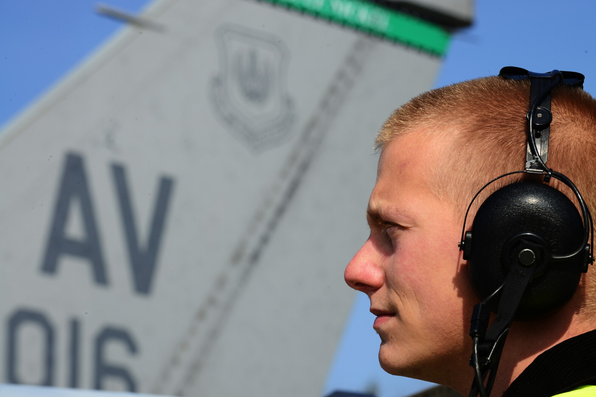 Senior Airman Sean Young, 31st Aircraft Maintenance Squadron crew chief, listens to a pilot through his headset, March 20, 2014, at Łask Air Base, Poland. Throughout the past week, maintainers from the 31st Aircraft Maintenance Squadron, the 555th Aircraft Maintenance Unit and various other maintenance flights have worked together to maintain and repair F-16 Fighting Falcons involved with numerous training sorties. (U.S. Air Force photo/Airman 1st Class Ryan Conroy/Released) 