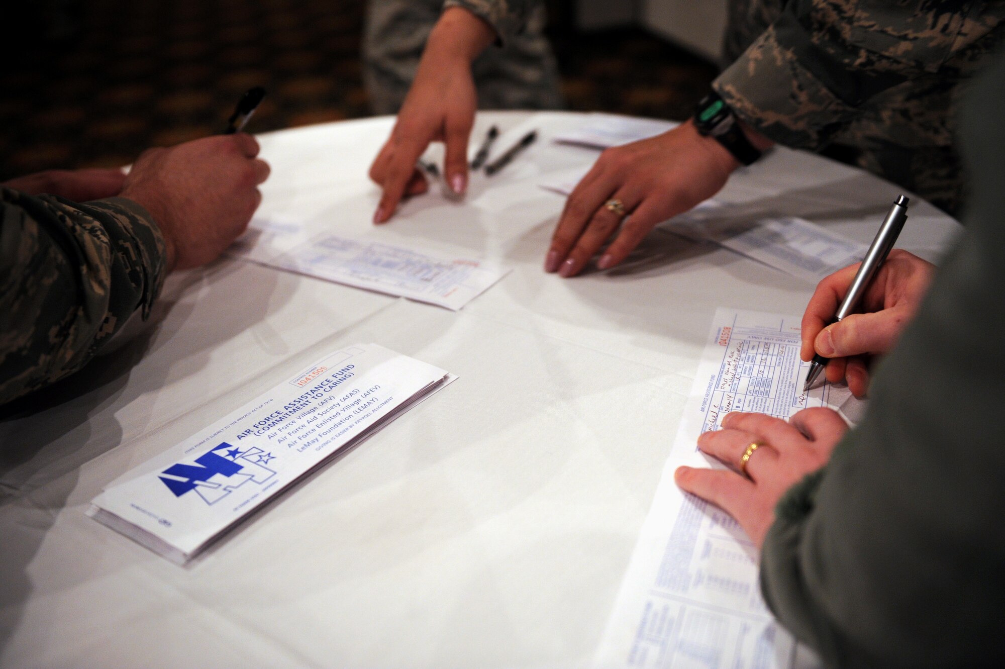 Team Osan members make their contributions to the Air Force Assistance Fund at Osan Air Base, Republic of Korea, March 24, 2014. The AFAF was established to provide an annual effort to raise funds for the charitable affiliates providing support to Air Force families including in need active duty, retirees, reservists, guard and their dependents and surviving spouses. (U.S. Air Force photo/Senior Airman Siuta B. Ika)