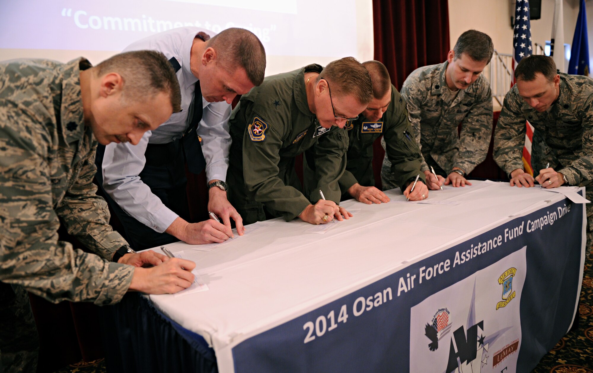 Team Osan leadership make their contributions to the Air Force Assistance Fund at Osan Air Base, Republic of Korea, March 24, 2014. The goal for this year’s drive is to bring in more than $105,000 for the Air Force Aid Society, which loaned more than $54,000 to 70 military families at Osan in 2013. (U.S. Air Force photo/Senior Airman Siuta B. Ika)
