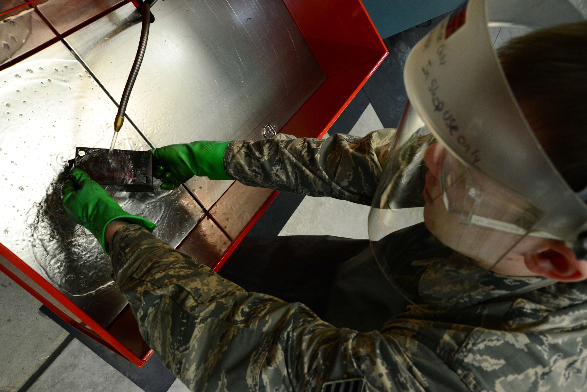 U.S. Air Force Staff Sgt. Timothy Schwenning, 35th Maintenance Squadron Nondestructive Inspection craftsman, rinses an F-16 Fighting Falcon’s hoist assembly part at Misawa Air Base, Japan, March 11, 2014. As an NDI craftsman, Schwenning and his shop of 15 maintainers perform more than 1,000 preventative maintenance inspections annually on F-16 parts. (U.S. Air Force photo/Senior Airman Derek VanHorn)