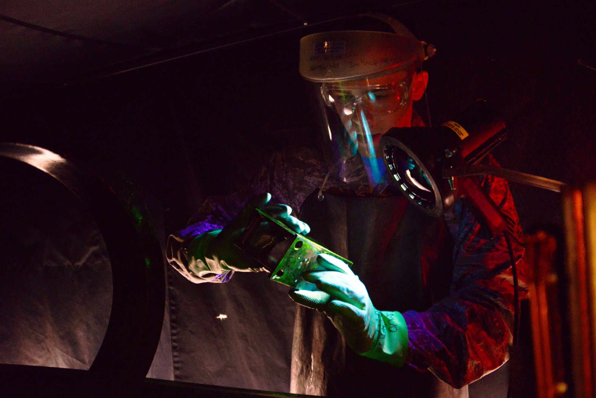 U.S. Air Force Staff Sgt. Timothy Schwenning, 35th Maintenance Squadron Nondestructive Inspection craftsman, inspects an F-16 Fighting Falcon's hoist assembly part using a stationary magnetic particle unit at Misawa Air Base, Japan, March 11, 2014. The hoist assembly part is soaked in mineral oil which acts as a vehicle to attract iron shavings to the part and identify any structural flaws for repair. (U.S. Air Force photo/Senior Airman Derek VanHorn)
