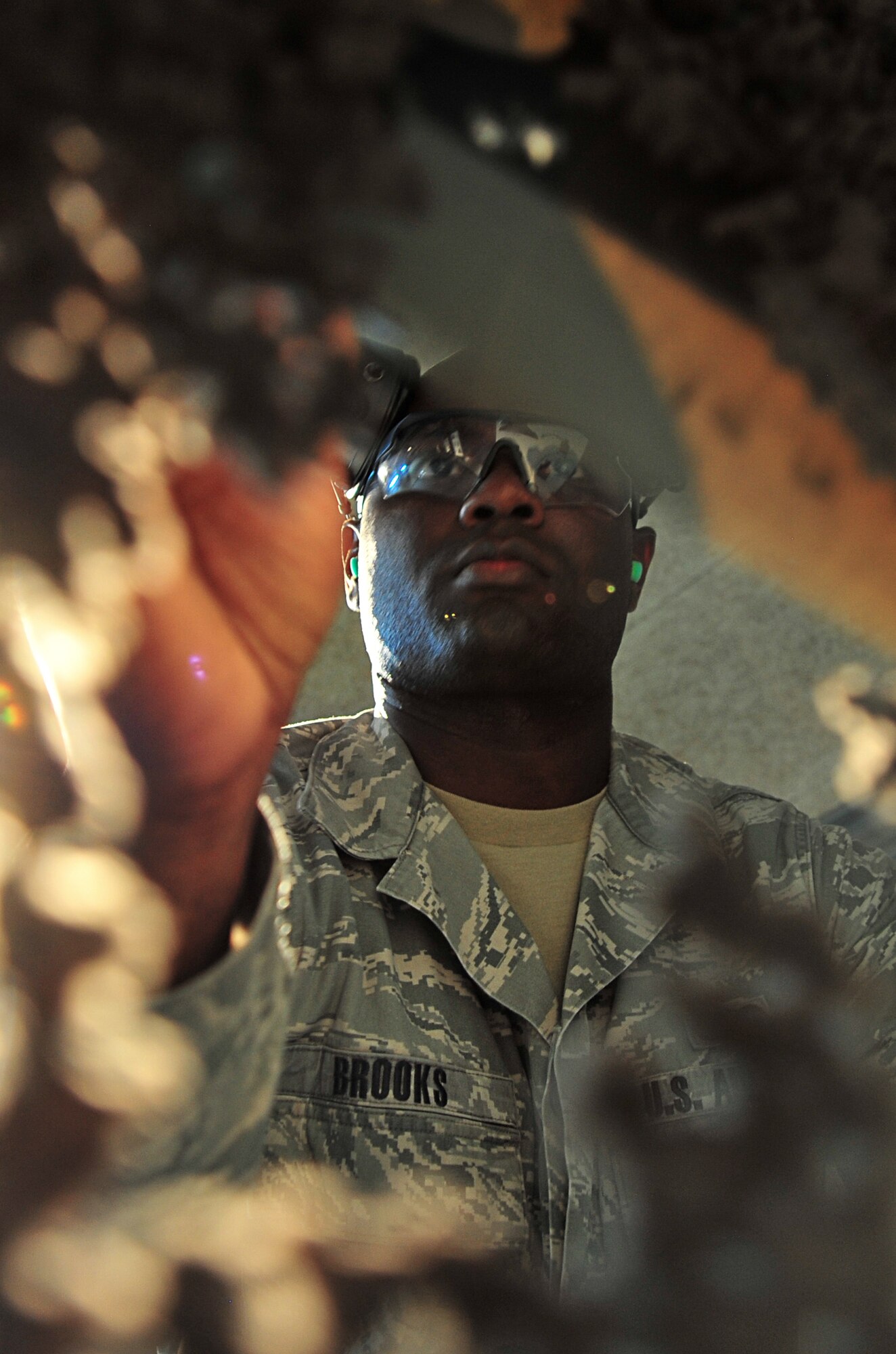 U.S. Air Force Staff Sgt. Kendrick Brooks, 35th Security Forces Squadron range official, scores a firing target sheet during a firearms qualification course at Misawa Air Base, Japan, March 20, 2014. Brooks tallies points on the score sheet and provides feedback to the shooters to help them improve accuracy. (U.S. Air Force photo/Senior Airman Jose L. Hernandez-Domitilo)