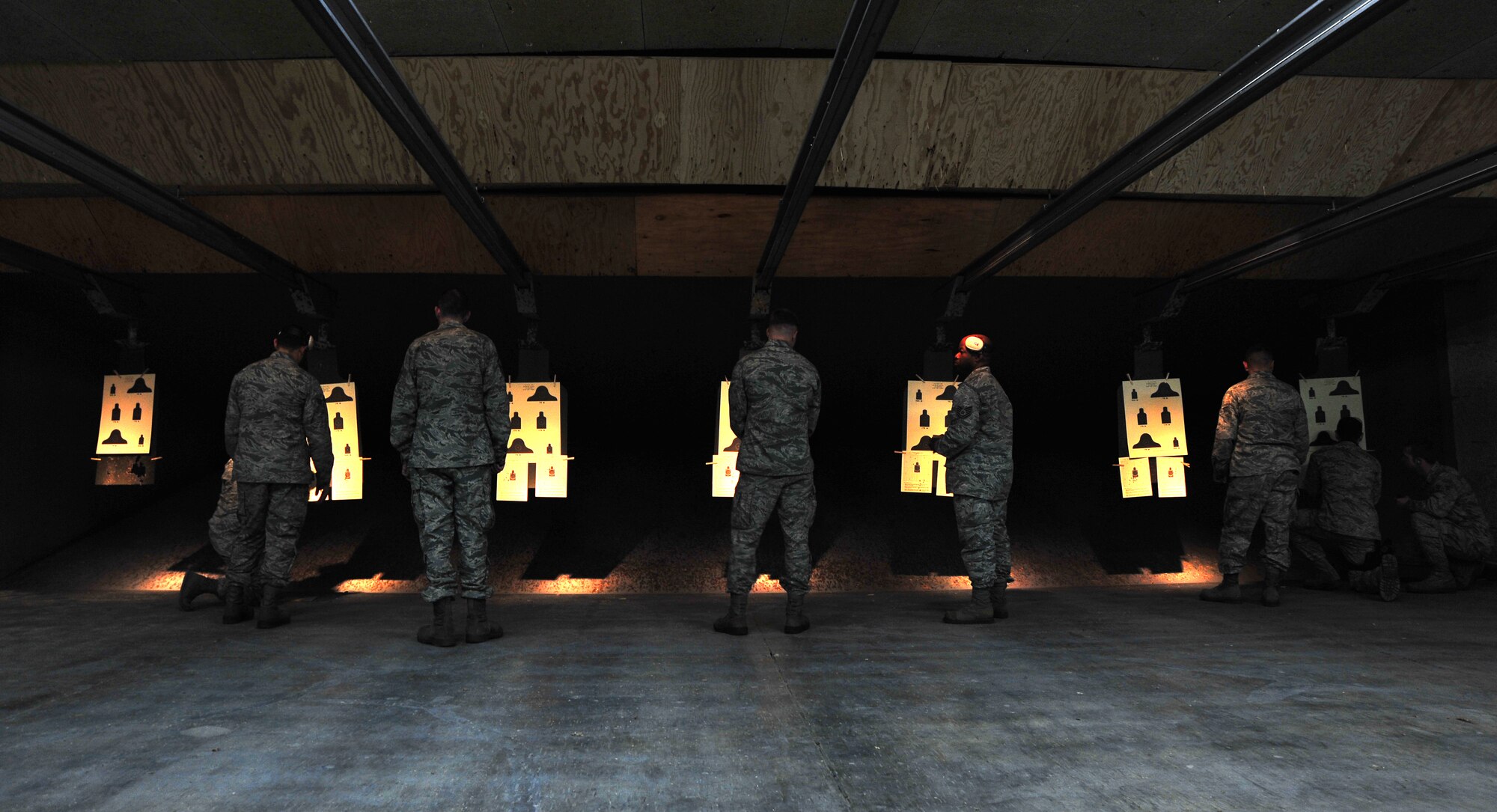 Airmen assigned to the 35th Maintenance Group review their firing target sheets with 35th Security Forces Squadron Combat Arms Training and Maintenance instructors following a qualification assessment at Misawa Air Base, Japan, March 20, 2014. Airmen must meet Air Force firearm qualification standards as part of a job requirement or deployment. (U.S. Air Force photo/Senior Airman Jose L. Hernandez-Domitilo)