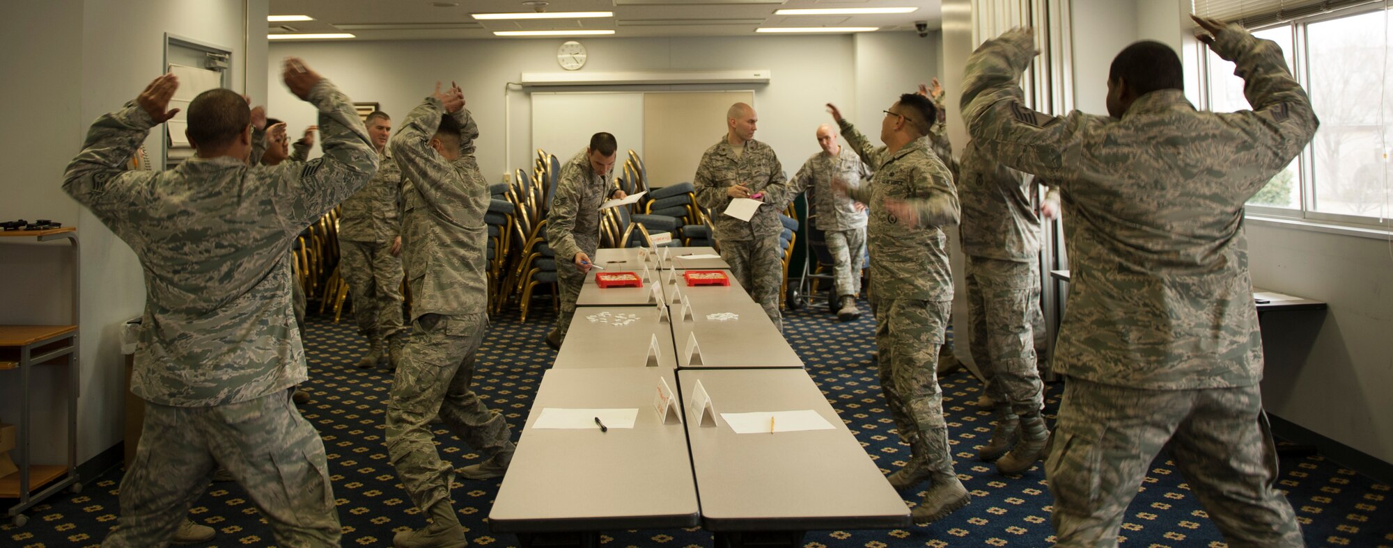 Security forces Airmen do jumping jacks during a training exercise Mar. 19, 2014, at Yokota Air Base, Japan. The defenders participated in a train the trainer course, which concluded with a comprehensive team competition. (U.S. Air Force photo by Senior Airman Desiree Economides)