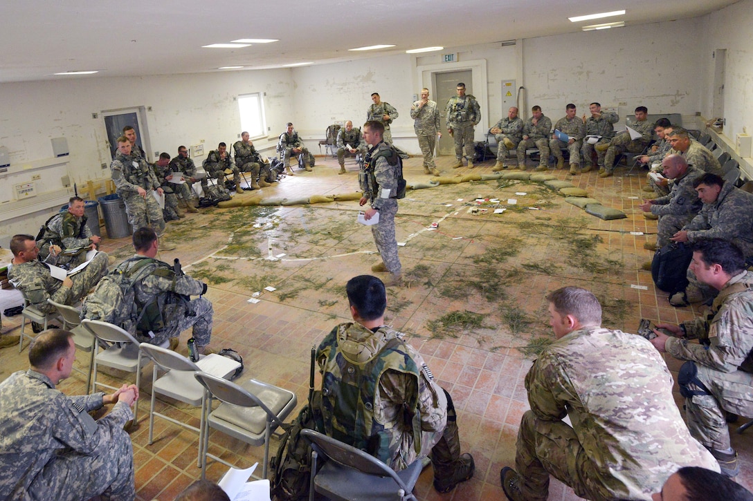 U.S. soldiers conduct a briefing before an air assault mission at the 7th Army Joint Multinational Training Command's Hohenfels Training Area, Germany, March 19, 2014. The soldiers are assigned to 12th Combat Aviation Brigade and the paratroopers are assigned to  1st Squadron, 91st Cavalry Regiment, 173rd Infantry Brigade Combat Team.