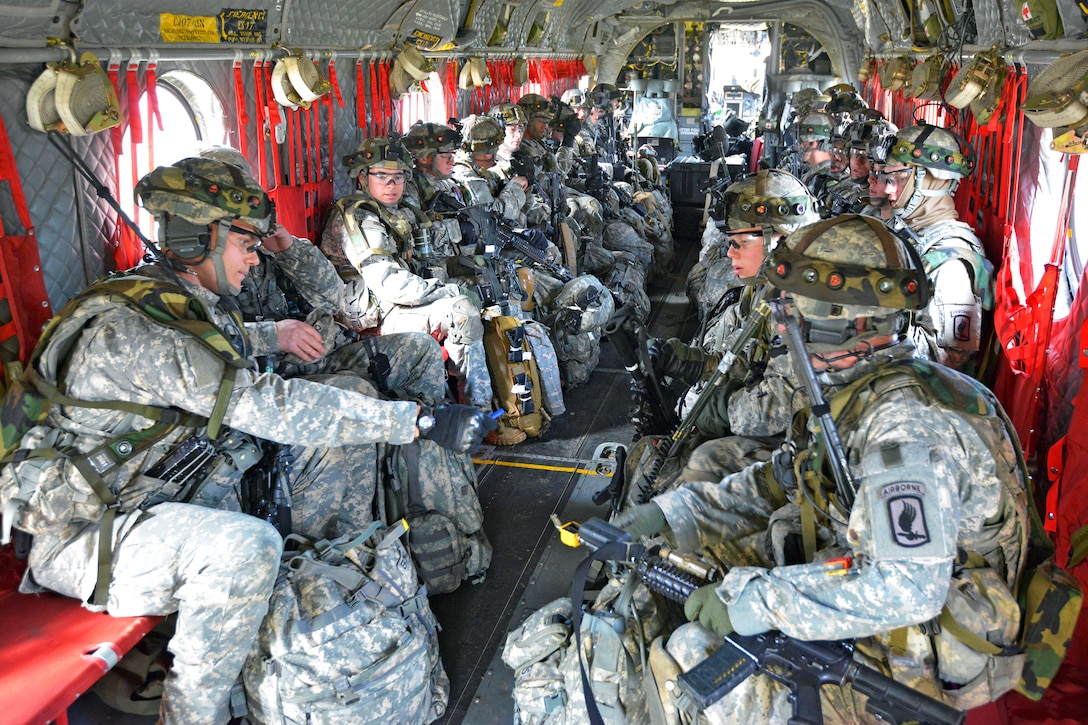 U.S. paratroopers sit inside a CH-47 Chinook helicopter before an air assault mission at the 7th Army Joint Multinational Training Command's Hohenfels Training Area, Germany, March 19, 2014. The helicopter crew is assigned to the 12th Combat Aviation Brigade.