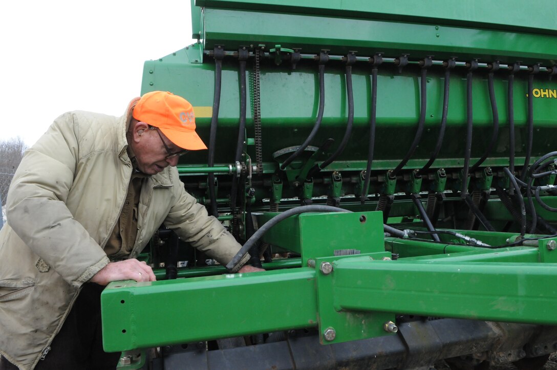 Retired Col. Frank Harris works on fixing the feeder tubes on an industrial seed planter belonging to the Natural Resources Section on March 12. Harris has been volunteering to do conservation work at Quantico since 1977, nine years before the official Conservation Volunteer Program got underway. 