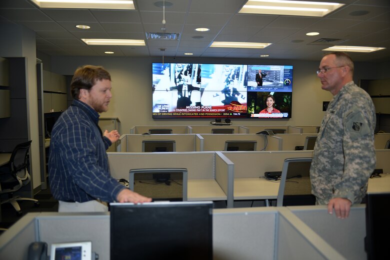 Kevin Gatlin, an emergency operations specialist at the Nashville District explains procedures for the new emergency operations center to U.S. Army Corps of Engineers' senior enlisted adviser Command Sgt. Maj. Karl J. Groninger during a visit to the district March 17, 2014.