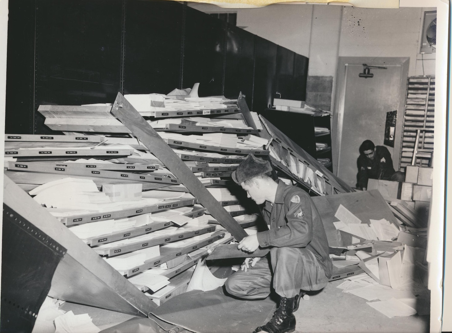 The large earthquake damaged National Guard offices in Alaska as well as civilian homes and facilities. These Guard members start cleaning up their own building in  Anchorage. They had just arrived there for annual training when the quake hit March 27, 1964.