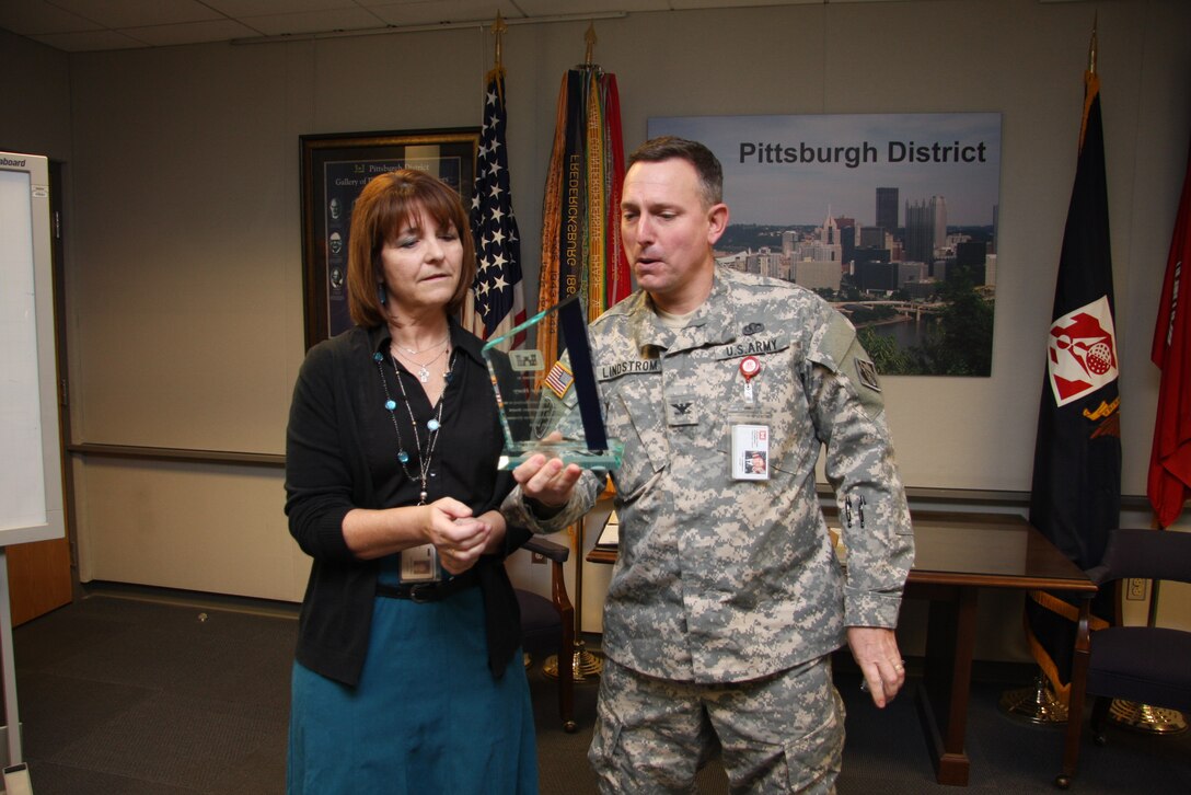 Col. Bernard Lindstrom present Jeanine Hoey an award for her contributions to the Regional Management Board Great Lakes and Ohio River Division from 2011 to 2013.