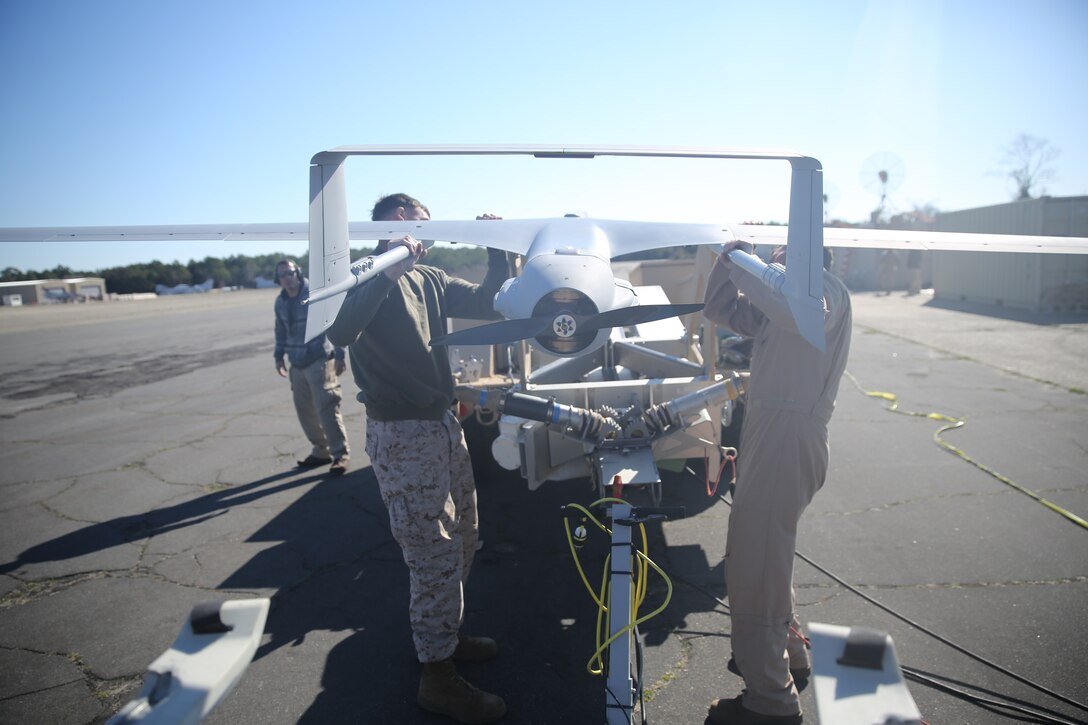 Lance Cpl. Kirk Humes, left, and Cpl. Johnnie Hays, right, place the RQ-21A Blackjack onto a launcher at Marine Corps Outlying Field Atlantic’s flight line, March 21, 2014. Both Humes and Hays are UAV maintainers with Marine Unmanned Aerial Vehicle Squadron 2.