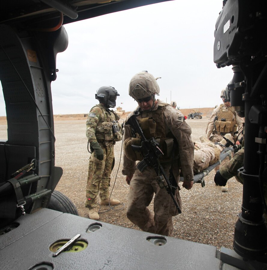 Marines with Regional Command (Southwest) carry a Marine with a simulated injury during a medical evacuation training exercise aboard Forward Operating Base Delaram II, Nimroz province, Afghanistan, March 14, 2014. Medevac crews operate out of FOB Delaram II in support of coalition forces patrolling in the surrounding area. (U.S. Marine Corps photo by Cpl. Cody Haas/ Released)
