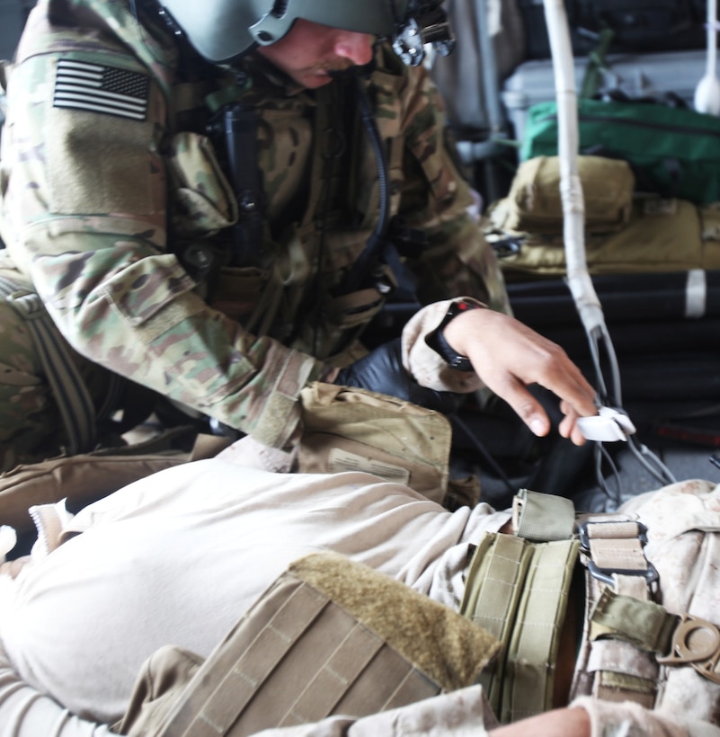 A flight medic with Golf Company, 2-135th General Support Aviation Battalion, monitors a simulated Marine casualty during a medical evacuation training exercise aboard Forward Operating Base Delaram II, Nimroz province, Afghanistan, March 14, 2014. Medevac crews operate out of FOB Delaram II in support of coalition forces patrolling in the surrounding area. (U.S. Marine Corps photo by Cpl. Cody Haas/ Released)