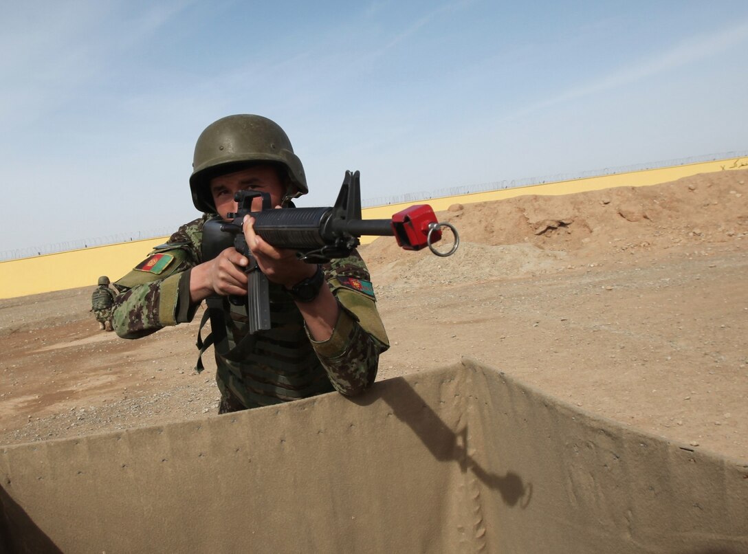 A soldier with the 215th Corps, Afghan National Army, provides security during a training course at Regional Corps Battle School aboard Camp Shorabak, Afghanistan, March 19, 2014. During the weeklong course, ANA soldiers with the 215th Corps learn proper techniques on how to forcefully enter an enemy-occupied building or compound, explosive ordnance disposal tactics and patrolling methods. (U.S. Marine Corps photo by Cpl. Cody Haas/ Released)