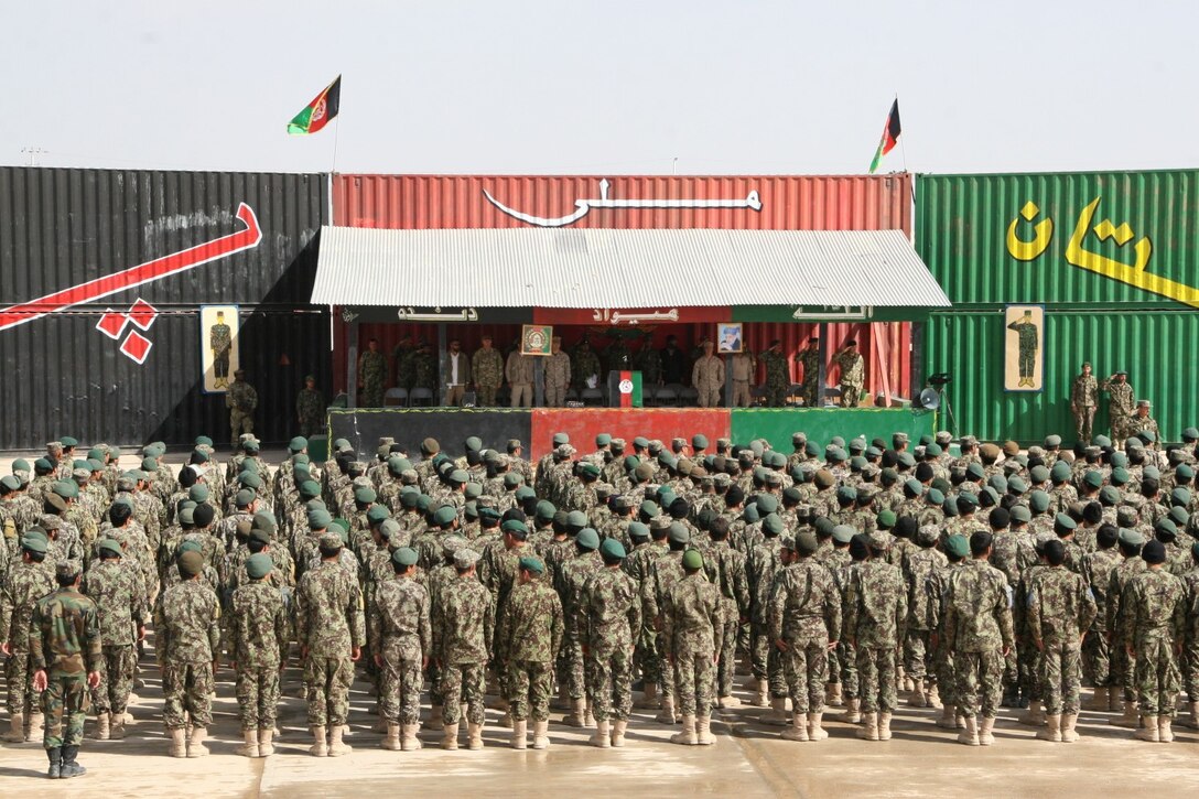 Afghan National Army 215th Corps soldiers stand in formation during their graduation from the Regional Corps Battle School aboard Camp Shorabak, Helmand province, Afghanistan, during a ceremony March 20, 2014. The training conducted at RCBS is Afghan-led, with Marines advising the Afghan instructors as needed.