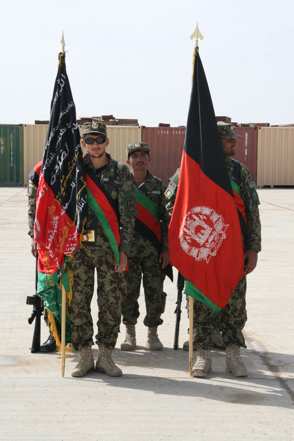 The Afghan National Army 215th Corps color guard waits for the Regional Corps Battle School graduation ceremony to begin aboard Camp Shorabak, Helmand province, Afghanistan, March 20, 2014. The training conducted at RCBS is Afghan-led, with Marines advising the Afghan instructors as needed.