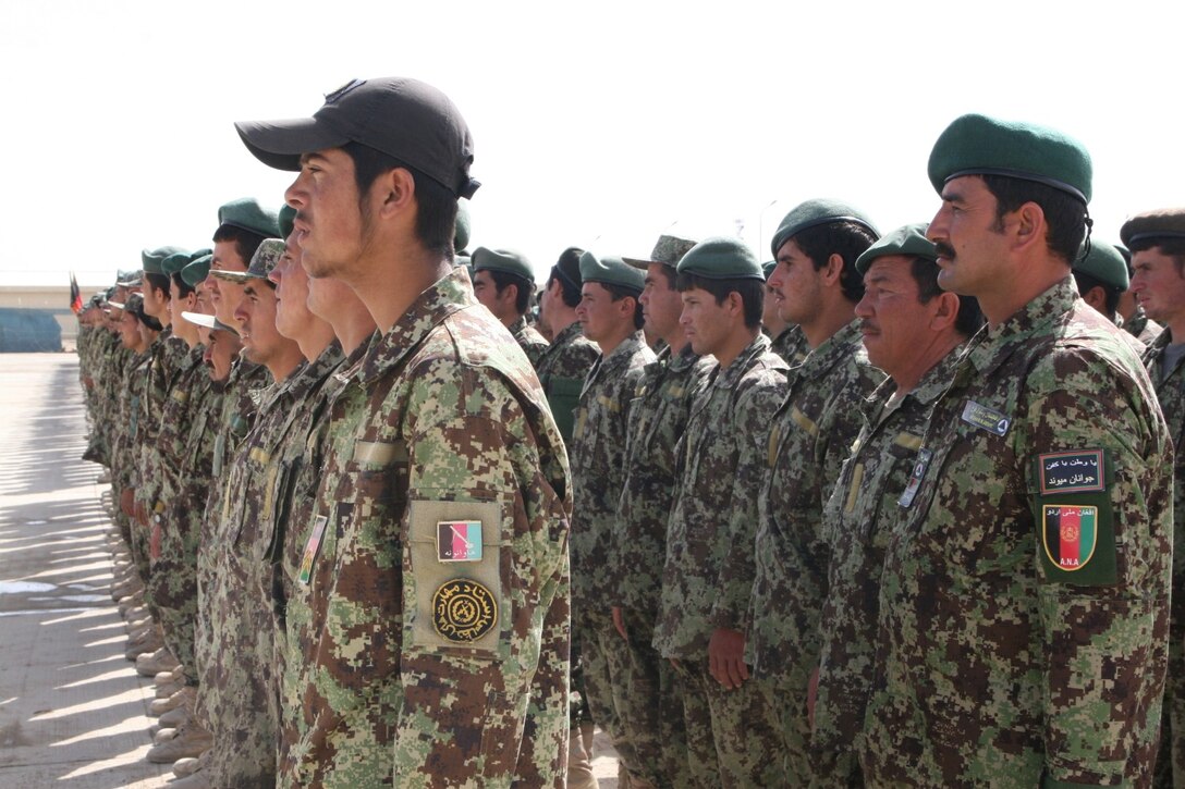 Afghan National Army 215th Corps soldiers stand in formation during their graduation from the Regional Corps Battle School aboard Camp Shorabak, Helmand province, Afghanistan, during a ceremony March 20, 2014. The training conducted at RCBS is Afghan-led, with Marines advising the Afghan instructors as needed.