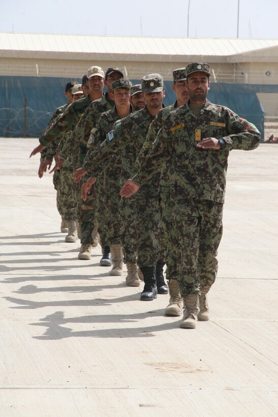 Afghan National Army 215th Corps soldiers and instructors with the Regional Corps Battle School march forward to receive graduation certificates during a ceremony held aboard Camp Shorabak, Helmand province, Afghanistan, March 20, 2014. The Afghan instructors are hand-selected by Marine advisors and trained and mentored on how to be an instructor, including how to teach military occupational specialty skill sets to their soldiers.