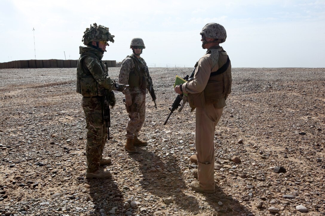 Flight Lt. Seb Cannon, left, the Mobile Aviation Operations Team commander with Joint Aviation Group; Capt. Matt Blose, center, the safety officer; and Capt. Roger Collicott, the helicopter landing zone manager, both with Marine Aircraft Group-Afghanistan, discuss the helicopter landing zone during an HLZ study at Patrol Base Boldak, Helmand province, Afghanistan, March 20, 2014.  Landing zone studies are performed as often as possible in order to update requirements and the coordination needed to maintain the HLZ, as well as to ensure proper procedures and safety requirements are set in place. (USMC Photo By: Sgt. Frances Johnson/Released)