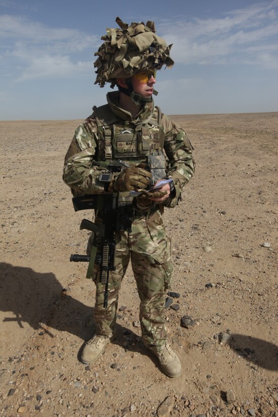 Flight Lt. Seb Cannon, the Mobile Aviation Operations Team commander with Joint Aviation Group, takes notes while conducting a helicopter landing zone study aboard Patrol Base Boldak, Helmand province, Afghanistan, March 20, 2014.  Landing zone studies are performed as often as possible in order to update requirements and the coordination needed to maintain the HLZ, as well as to ensure proper procedures and safety requirements are set in place. (USMC Photo By: Sgt. Frances Johnson/Released)