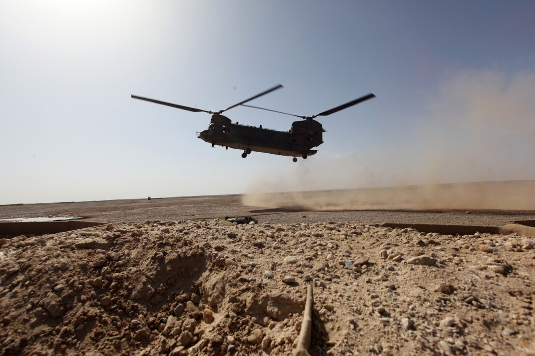 A CH-47 Chinook prepares to land after a team conducted a helicopter landing zone study aboard Patrol Base Boldak, Helmand province, Afghanistan, March 20, 2014.  Landing zone studies are performed as often as possible in order to update requirements and the coordination needed to maintain the HLZ, as well as to ensure proper procedures and safety requirements are set in place. (USMC Photo By: Sgt. Frances Johnson/Released)