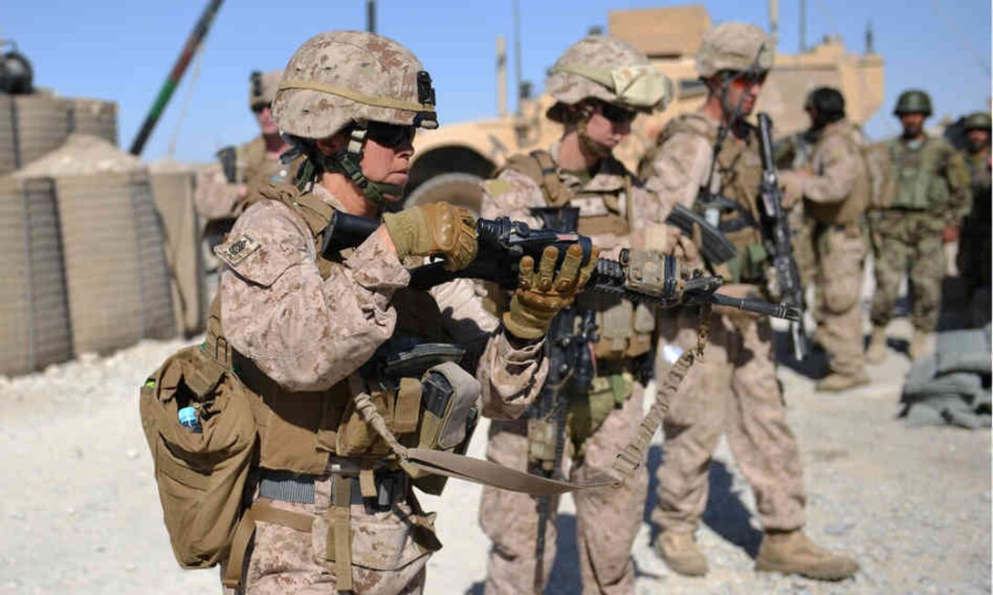 Female Marines check their rifles after a patrol with Afghan soldiers in Helmand Province, Afghanistan, while on deployment in June 2012. Women today are allowed to deploy to third-world countries and hostile environments thanks to continued changes in how women in the military are treated.