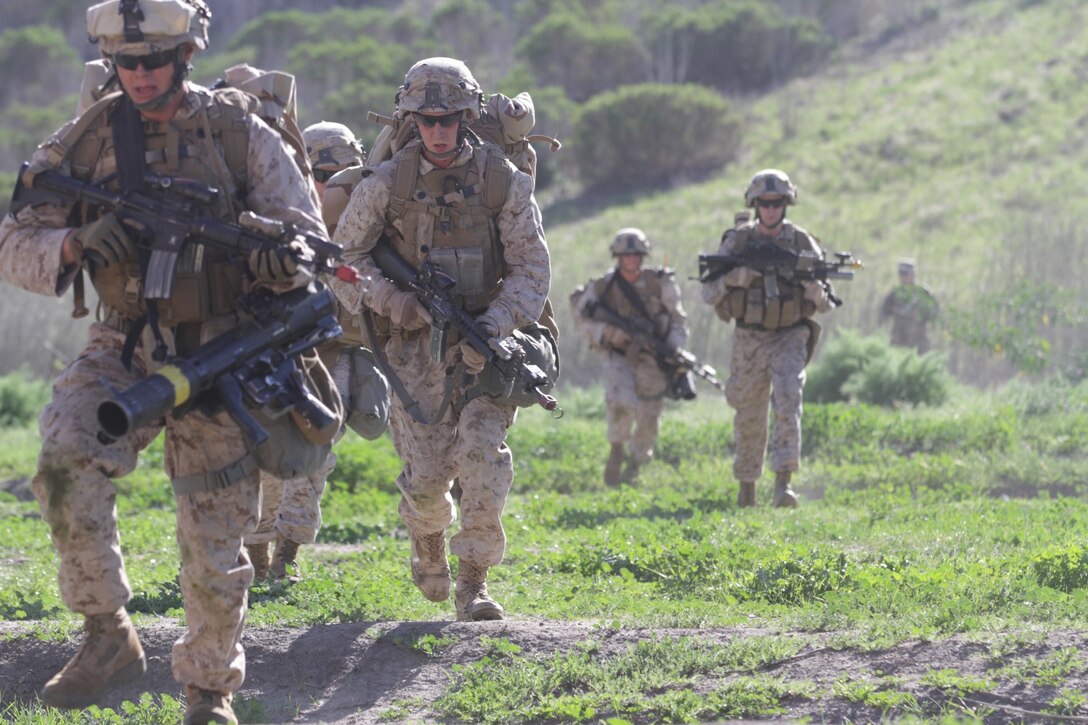 Marines with Kilo Company, 3rd Battalion, 5th Marine Regiment, move to assist during a raid as part of a Marine Corps Combat Readiness Evaluation aboard Marine Corps Base Camp Pendleton, Calif., March 19, 2014. The MCCRE is a week long exercise that tests Marines' combat readiness through a variety of scenarios. Raids, gas drills and casualty evacuations are among the tests used to evaluate the Marines. (U.S. Marine Corps photo by Lance Cpl. David Silvano/released)