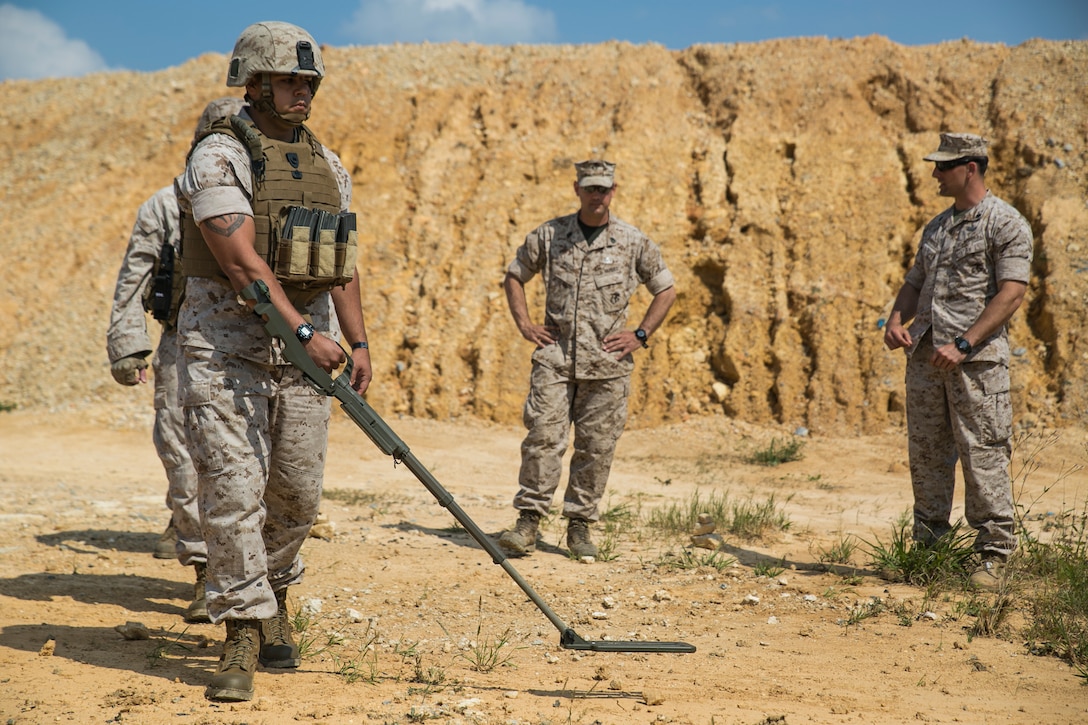 Explosive ordnance disposal technicians observe military working dog handlers searching for simulated improvised explosive devices March 24 at Camp Hansen. The training prepares the handlers for possible scenarios encountered in a deployed environment. The EOD technicians are with 9th Engineer Support Battalion, 3rd Marine Logistics Group, III Marine Expeditionary Force.  The military working dog handlers are with 3rd Law Enforcement Battalion, III Marine Expeditionary Force Headquarters Group, III MEF.