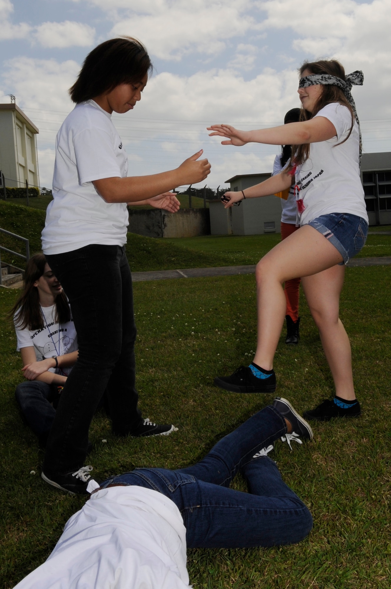 High school students take turns guiding a blindfolded individual through an obstacle course using only their voice during Operation Snowball at Kadena High School on Kadena Air Base, Japan, March 22, 2014. The students were taught how to effectively communicate, be assertive while still being polite to each other. (U.S. Air Force photo by Senior Airman Marcus Morris) 