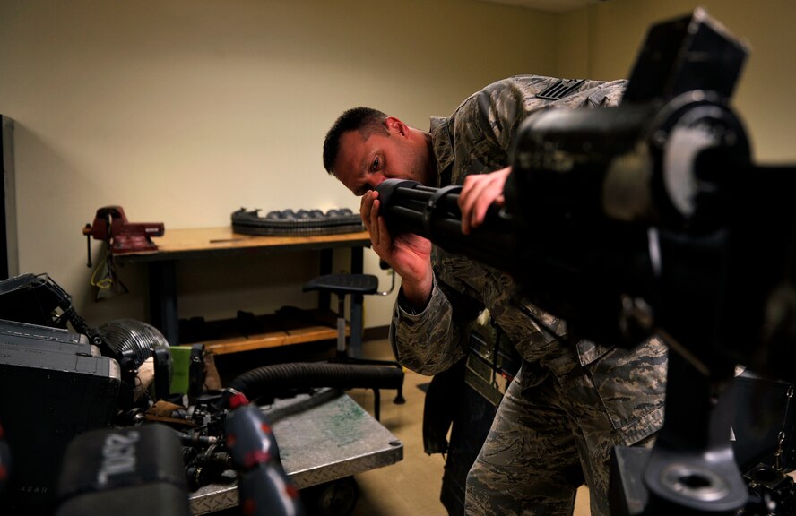 U.S. Air Force Staff Sgt. Brent Helm, 33rd Helicopter Maintenance Unit weapons team chief, inspects the mini-gun of an HH-60G Pave Hawk helicopter during a scheduled inspection on Kadena Air Base, Japan, March 14, 2014. Maintenance and inspections are conducted before and after every mission to ensure aircraft safety and longevity. (U.S. Air Force photo by Naoto Anazawa)