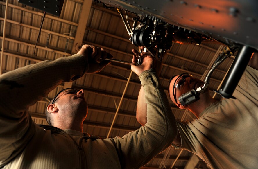 U.S. Air Force Staff Sgt. Kevin Roth (right) and Senior Airman Jason Sanada (left), both 33rd Helicopter Maintenance Unit crew chiefs, inspect the tail gear box of an HH-60G Pave Hawk helicopter on Kadena Air Base, Japan, March 14, 2014. All aircraft must be maintained and inspected for mission readiness to ensure the safety of each flight. (U.S. Air Force photo by Naoto Anazawa)