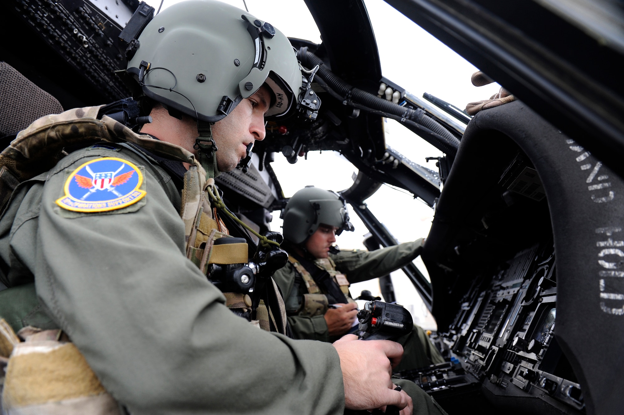 U.S. Air Force Capt. Colin Degroote and 1st Lt. Dirk Strykowski, both 33rd Rescue Squadron HH-60G Pave Hawk helicopter pilots, begin pre-flight checks before a training mission on Kadena Air Base, Japan, March 20, 2014. The 33rd RQS frequently trains on a multitude of scenarios in order to stay prepared for potential real-world contingencies and operations. (U.S. Air Force photo by Senior Airman Maeson L. Elleman)
