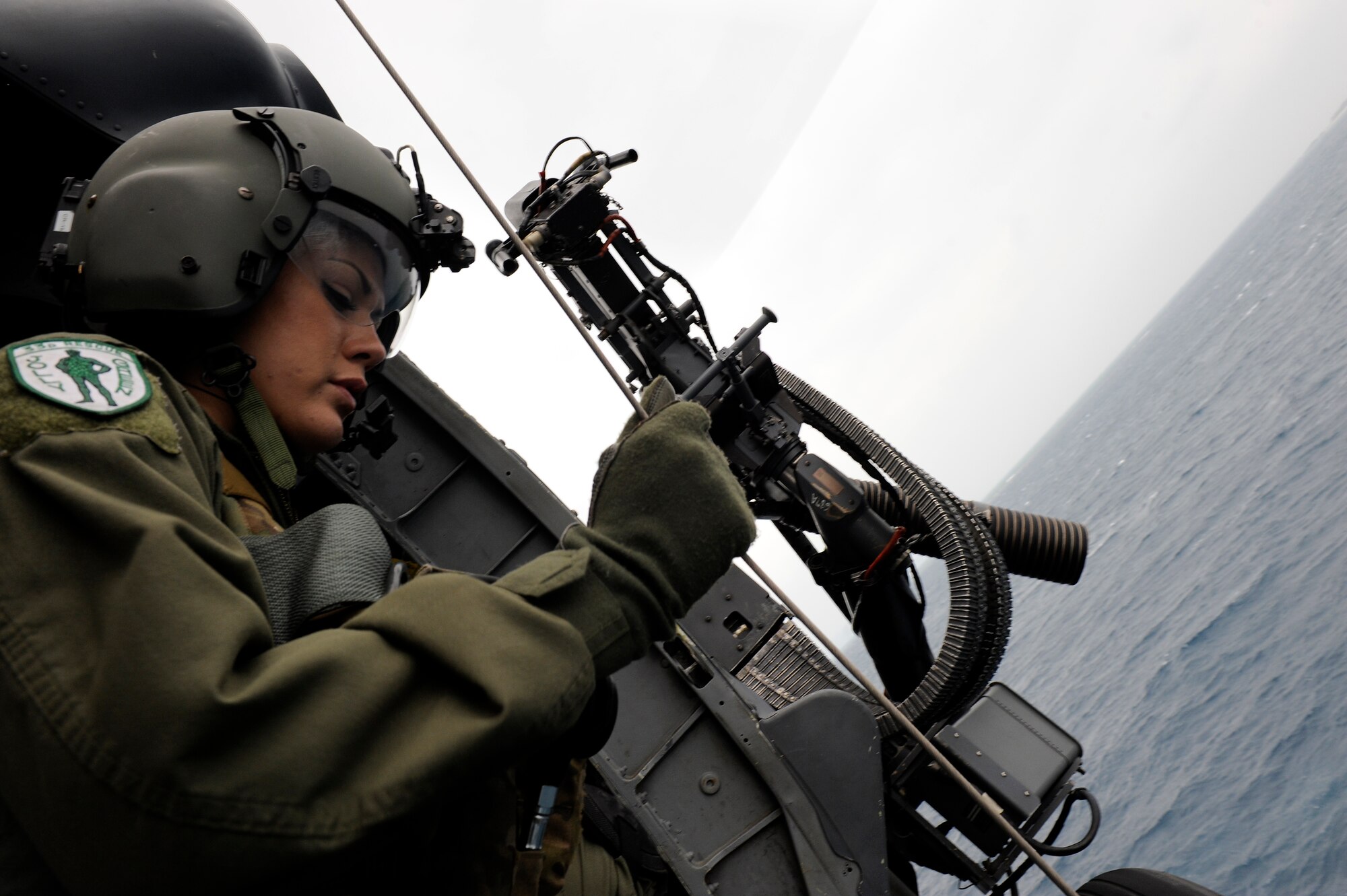 U.S. Air Force Tech. Sgt. Jewel Steamer, 33rd Rescue Squadron flight engineer, lowers an HH-60G Pave Hawk helicopter hoist during a training flight near Okinawa, Japan, March 20, 2014. During the training, members of the 33rd RQS performed an array of maneuvers and procedures to include hoist and .50 caliber machinegun training. (U.S. Air Force photo by Senior Airman Maeson L. Elleman)