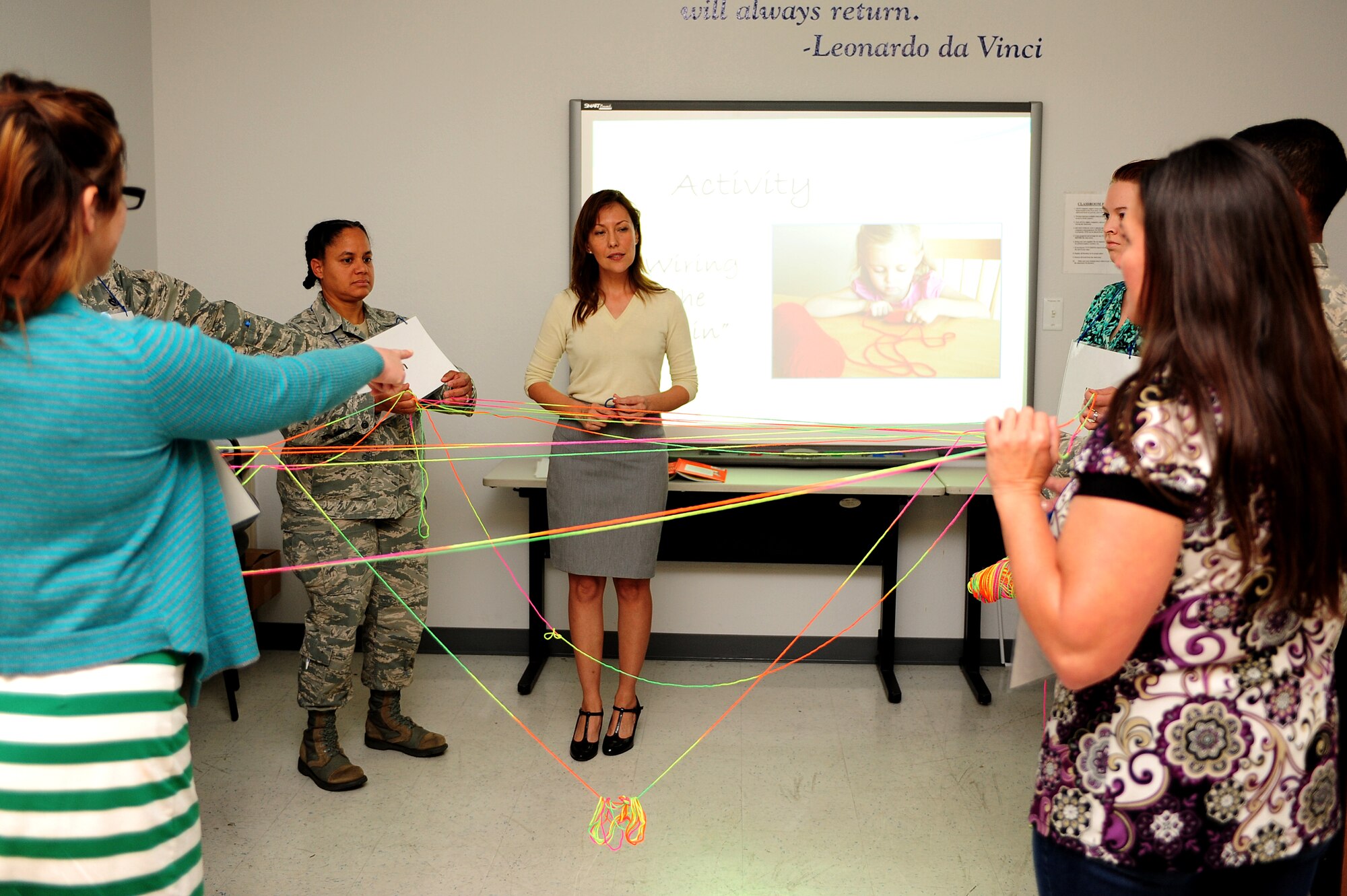 Ana Bae, Brain Waves program coordinator, explains myelination through an activity during a Brain Waves training course with Desert Lightning Team members at Davis-Monthan Air Force Base, Ariz., March 26, 2014. Myelination enables nerve cells to transmit information faster and allows for more complex brain processes. It begins in infancy and continues into adulthood. (Air Force photo by Senior Airman Camilla Elizeu/ Released)