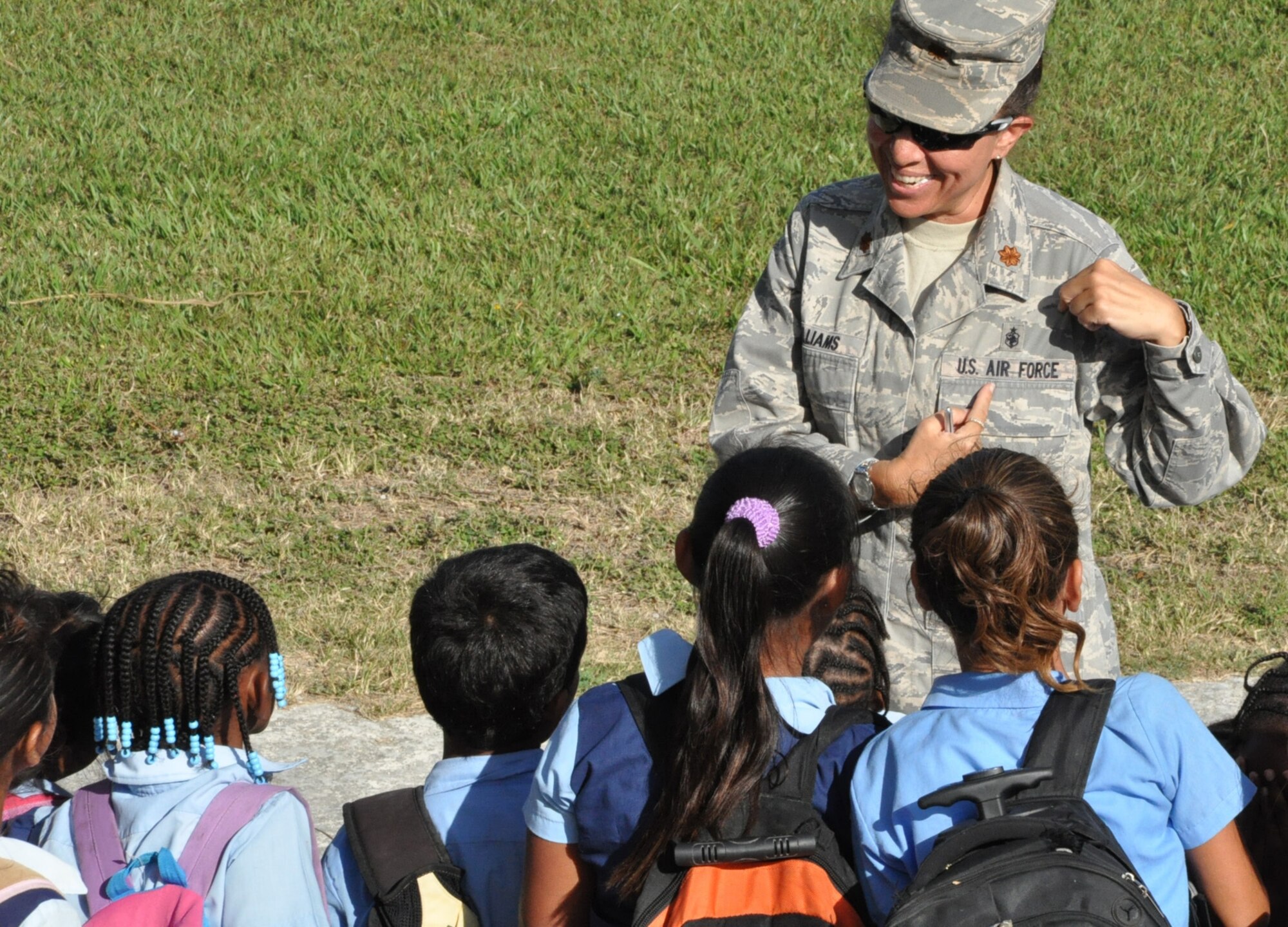 Maj. S. Kellie Williams, New Horizons Expeditionary Medical Operations Squadron deputy commander, explains her medical occupational badge and her position in the U.S. Air Force to students at the Libertad Methodist School March 24, 2014, in Libertad, Belize. Williams and other U.S. military medical representatives visited three schools in the Corozal region in preparation for upcoming medical readiness training exercises, or MEDRETES, which will incorporate the training and medical expertise of both Belizean and U.S. medical professionals as they learn from one another to provide medical care to residents near Chunox, Progresso and Libertad. (U.S. Air Force photo by Tech. Sgt. Kali L. Gradishar/Released)