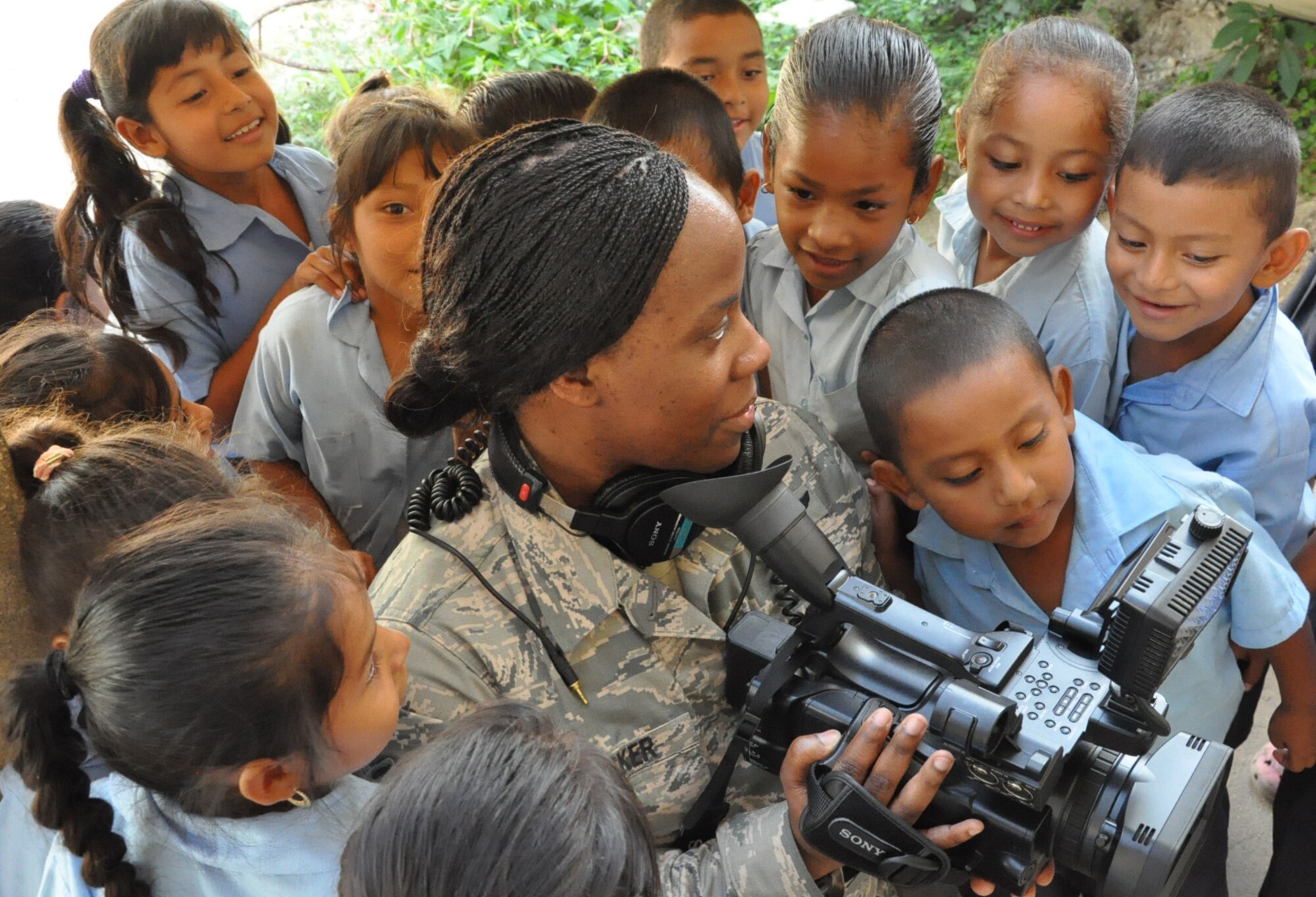 Tech. Sgt. Brandy Stocker, New Horizons Public Affairs broadcast journalist, shows children video footage of themselves March 24, 2014, during a visit to Progresso R. C. School in Progresso, Belize. Belizean government and U.S. military representatives visited three schools in the Corozal region in preparation for upcoming medical readiness training exercises, or MEDRETES, which will incorporate the training and medical expertise of both Belizean and U.S. medical professionals as they learn from one another to provide medical care to residents near Chunox, Progresso and Libertad. (U.S. Air Force photo by Tech. Sgt. Kali L. Gradishar/Released)