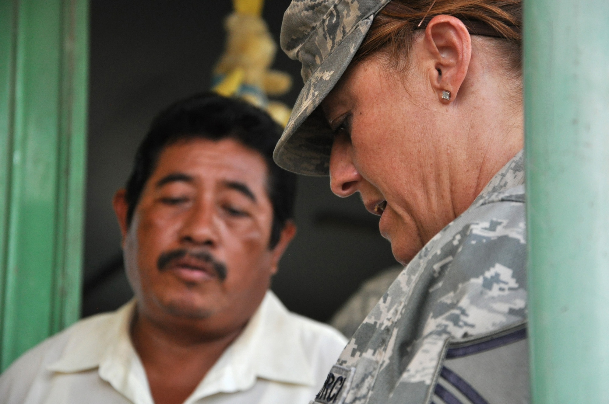 U.S. Air Force Master Sgt. Theresa Simonetti, Air Forces Southern Surgeon General medical planner, right, takes notes and gets contact information from the Chunox R.C. Pre-School principal March 24, 2014, in Chunox, Belize. The Chunox preschool is one of three locations in the Corozal area to be used as a temporary medical facility. Belizean and U.S. military medical professionals will share their training, expertise and knowledge with each other during medical readiness training exercises, or MEDRETES, as they offer medical care to residents near Chunox, Progresso and Libertad. (U.S. Air Force photo by Tech. Sgt. Kali L. Gradishar/Released)