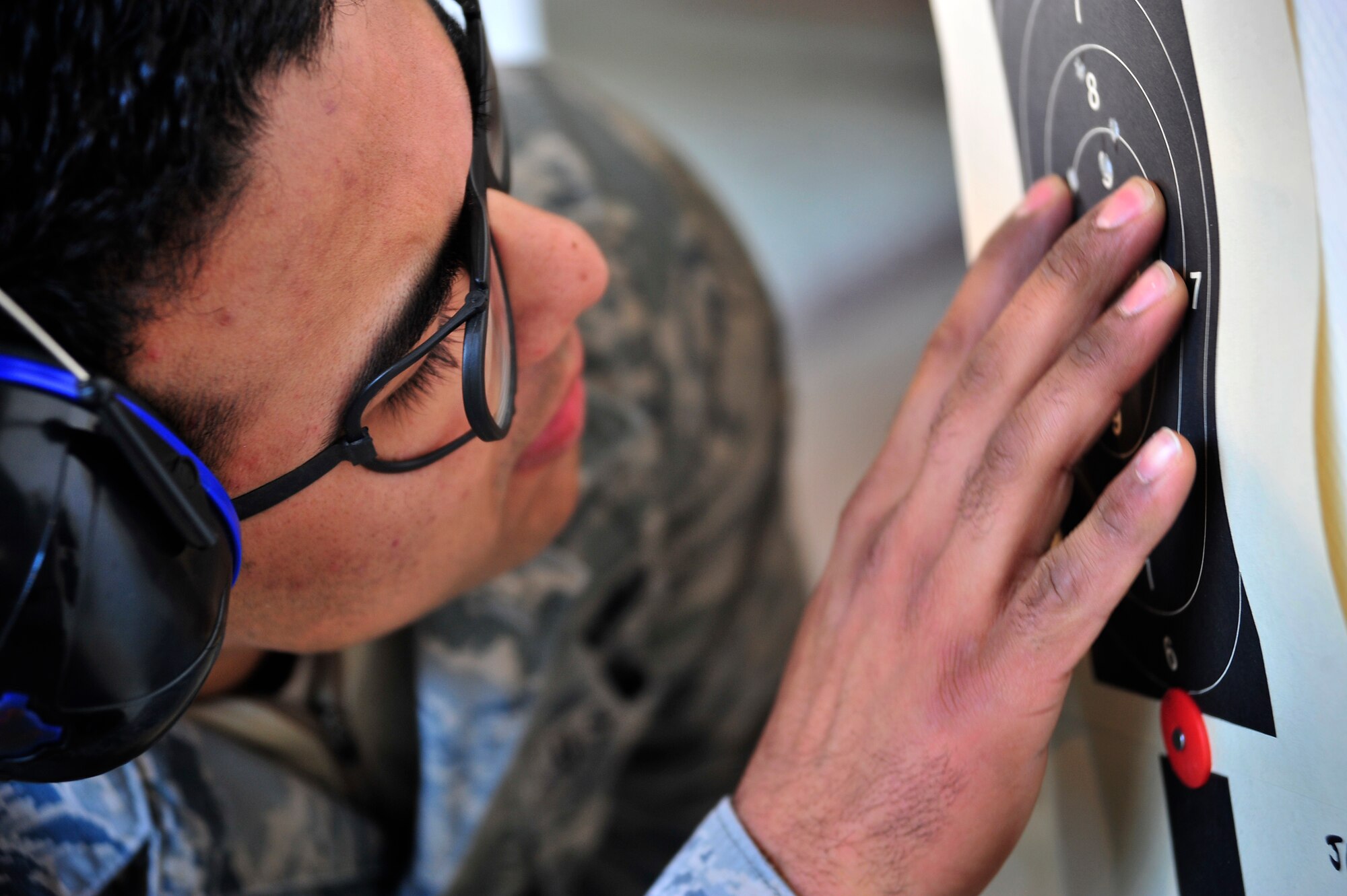 Senior Airman Jose Lucero, 436th Security Forces Squadron raven team leader, carefully examines his target during an Excellence in Competition rifle match March 21, 2014, at Dover Air Force Base, Del. The 436th Security Forces Squadron provided both the M16A2 rifle and the ammunition for the event. (U.S. Air Force photo/Staff Sgt. Elizabeth Morris)