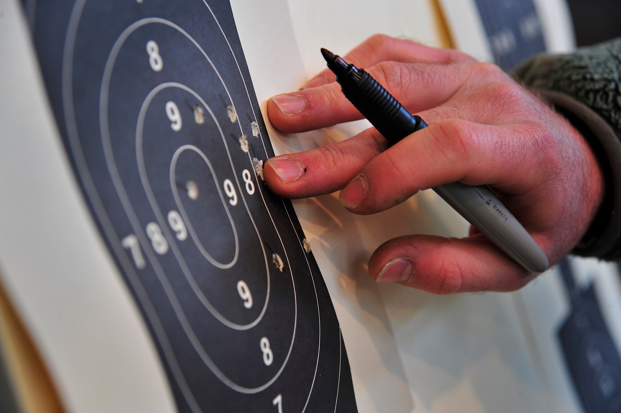 A 436th Security Forces Squadron combat arms instructor scores a target during an Excellence in Competition rifle match March 21, 2014, at Dover Air Force Base, Del. The competition was open to all active duty, reserve and guard Air Force personnel. (U.S. Air Force photo/Staff Sgt. Elizabeth Morris)