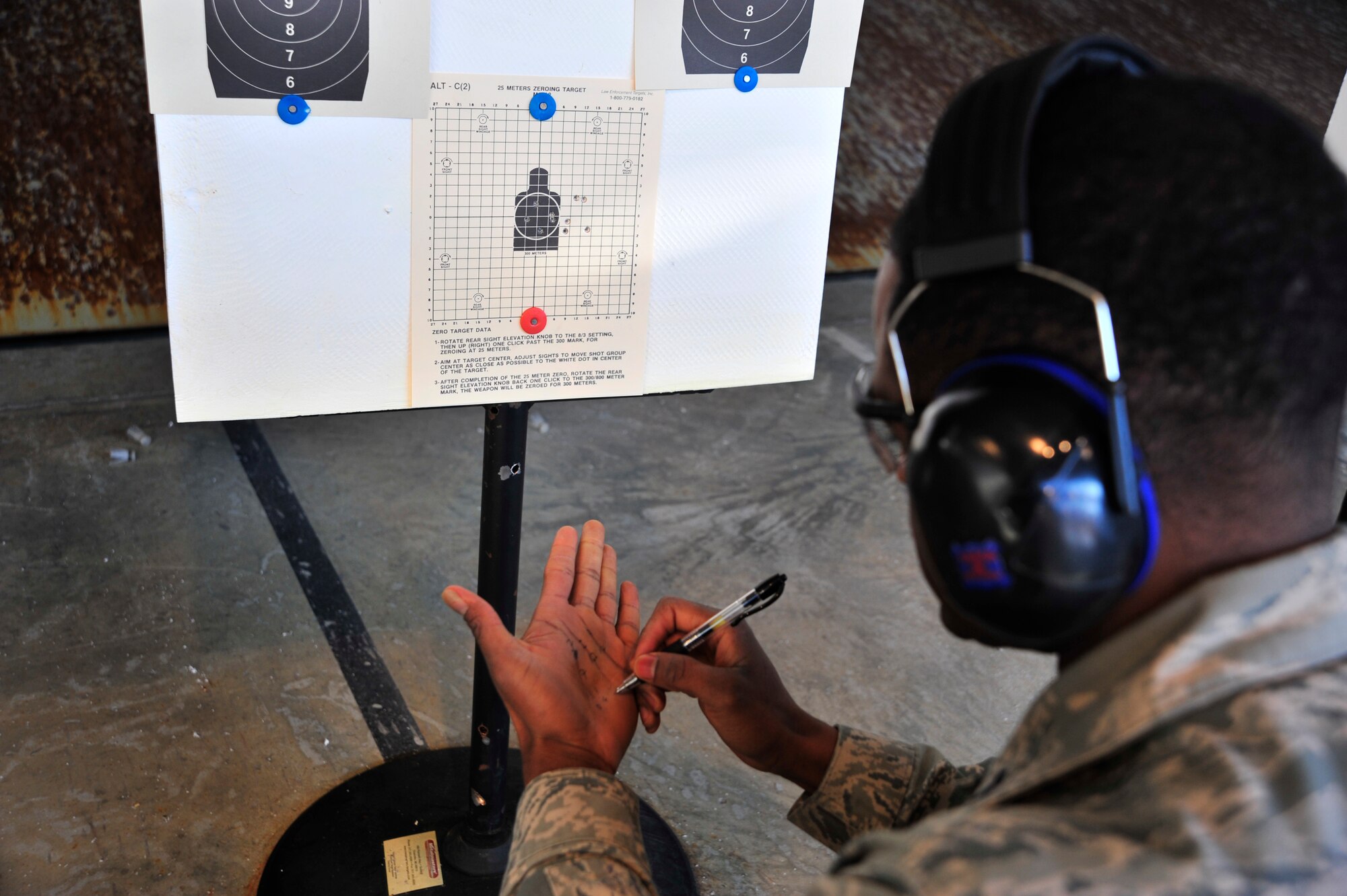 1st Lt. Kevin Ngala, 436th Aerospace Medical Squadron public health deputy flight commander, determines his sight corrections during an Excellence in Competition rifle match sponsored the the 436th Security Forces Squadron March 21, 2014, at Dover Air Force Base, Del. Ngala had the top score in the competition and qualified for the bronze EIC medal. (U.S. Air Force photo/Staff Sgt. Elizabeth Morris)